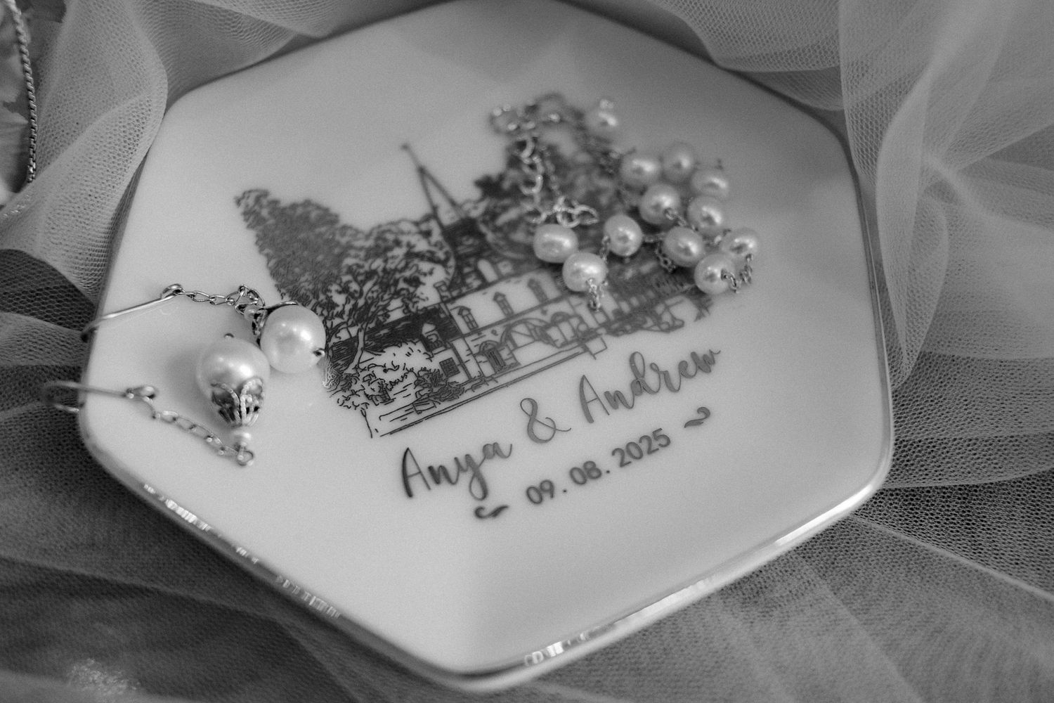 Decorative wedding plate with elegant text and floral designs in black and white.