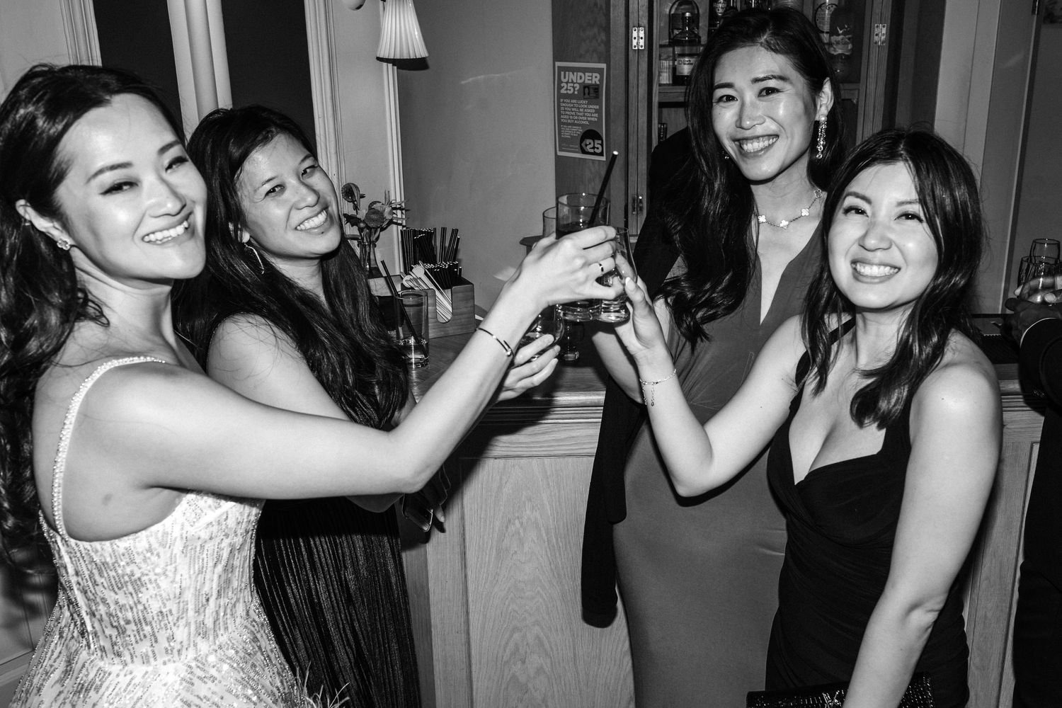 Black and white photos capturing candid moments of celebration at a wedding reception.