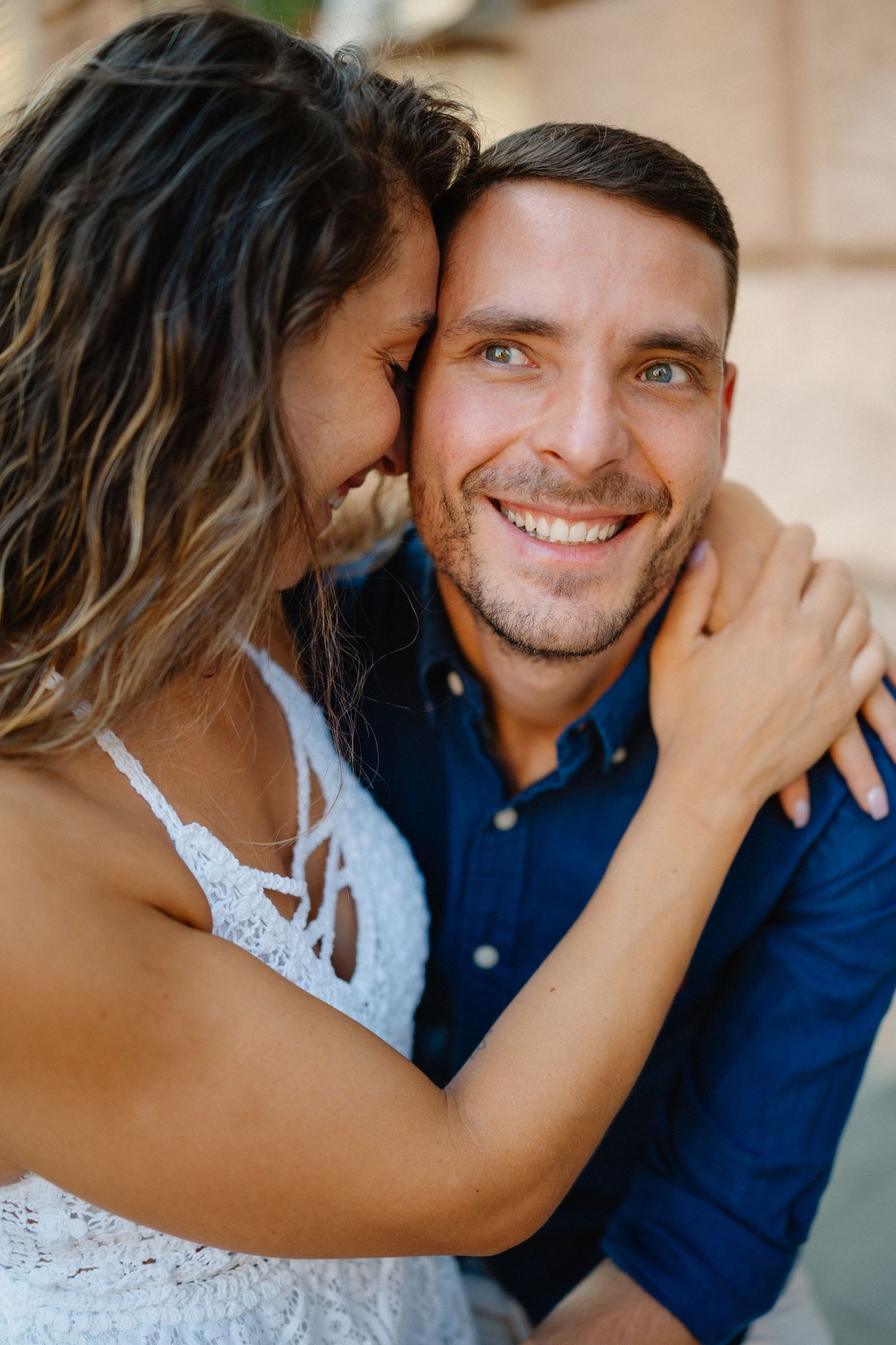 Playful couple sharing tender moments and laughter in casual outdoor portraits.
