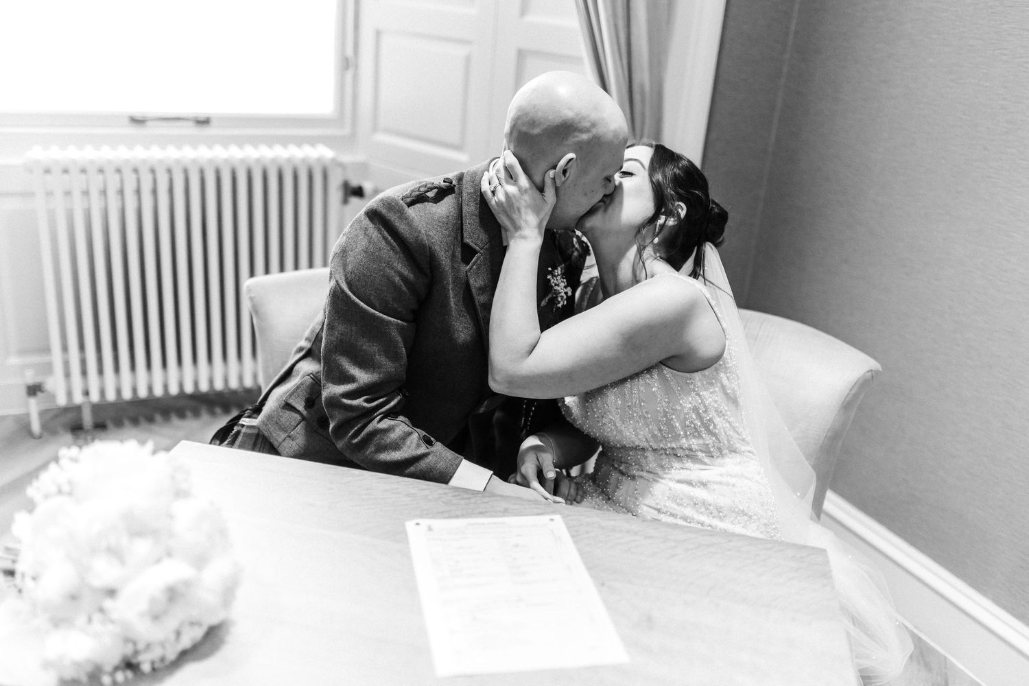 Kissing married couple after signing the documents,  City Chambers wedding in Edinburgh, Scotland,
