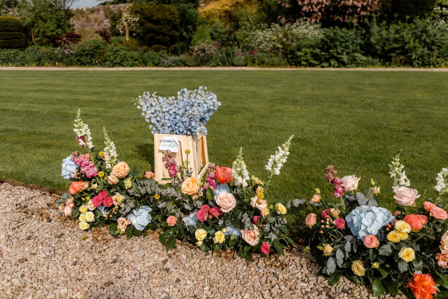 A panoramic view of a landscaped garden with colorful flowers and stone pathways.