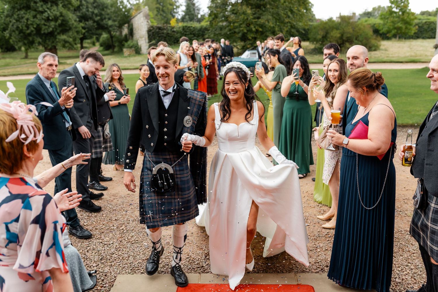 Wedding guests gather outdoors for a celebration at a scenic venue.