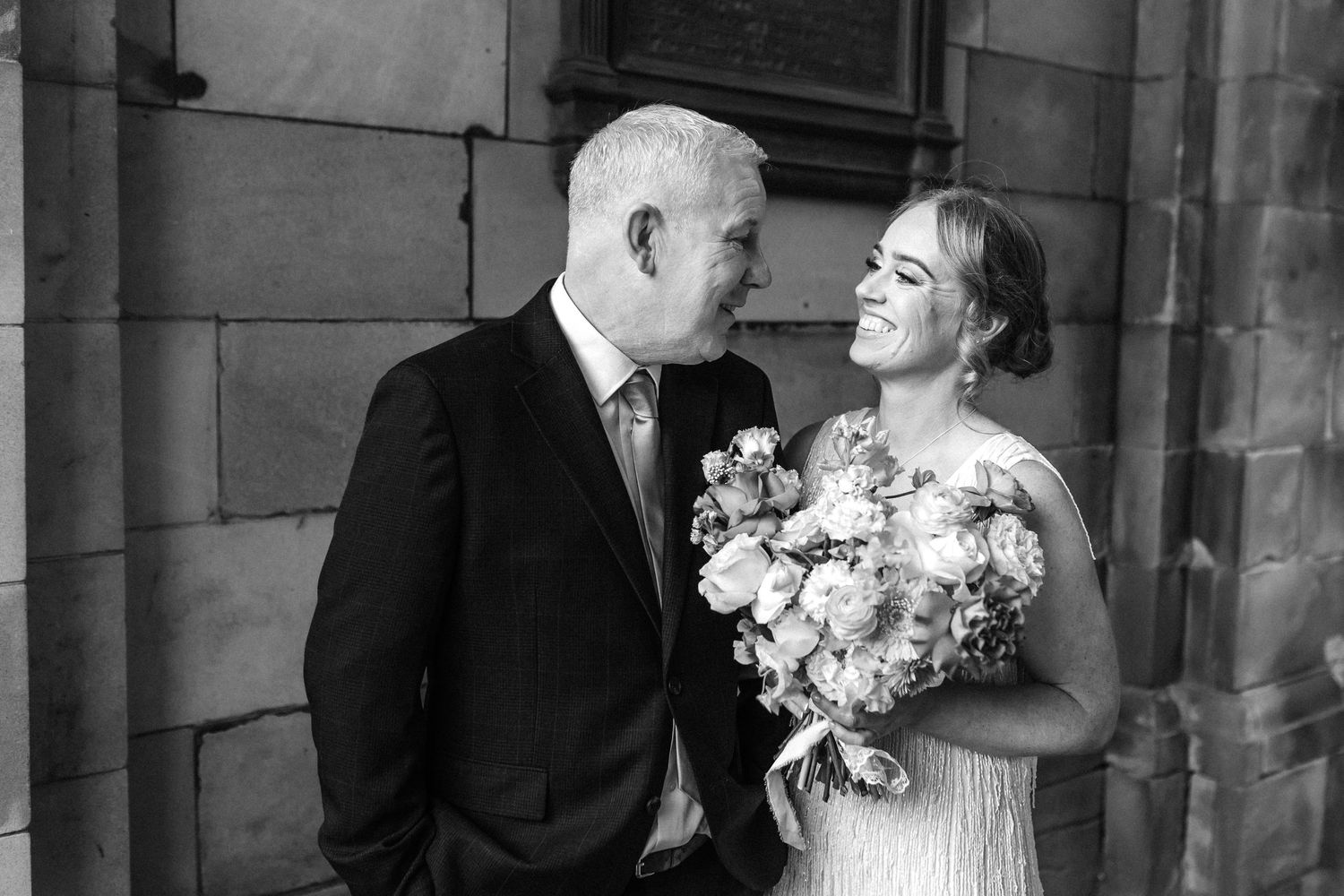 Black and white portrait of wedding couple sharing romantic moment.