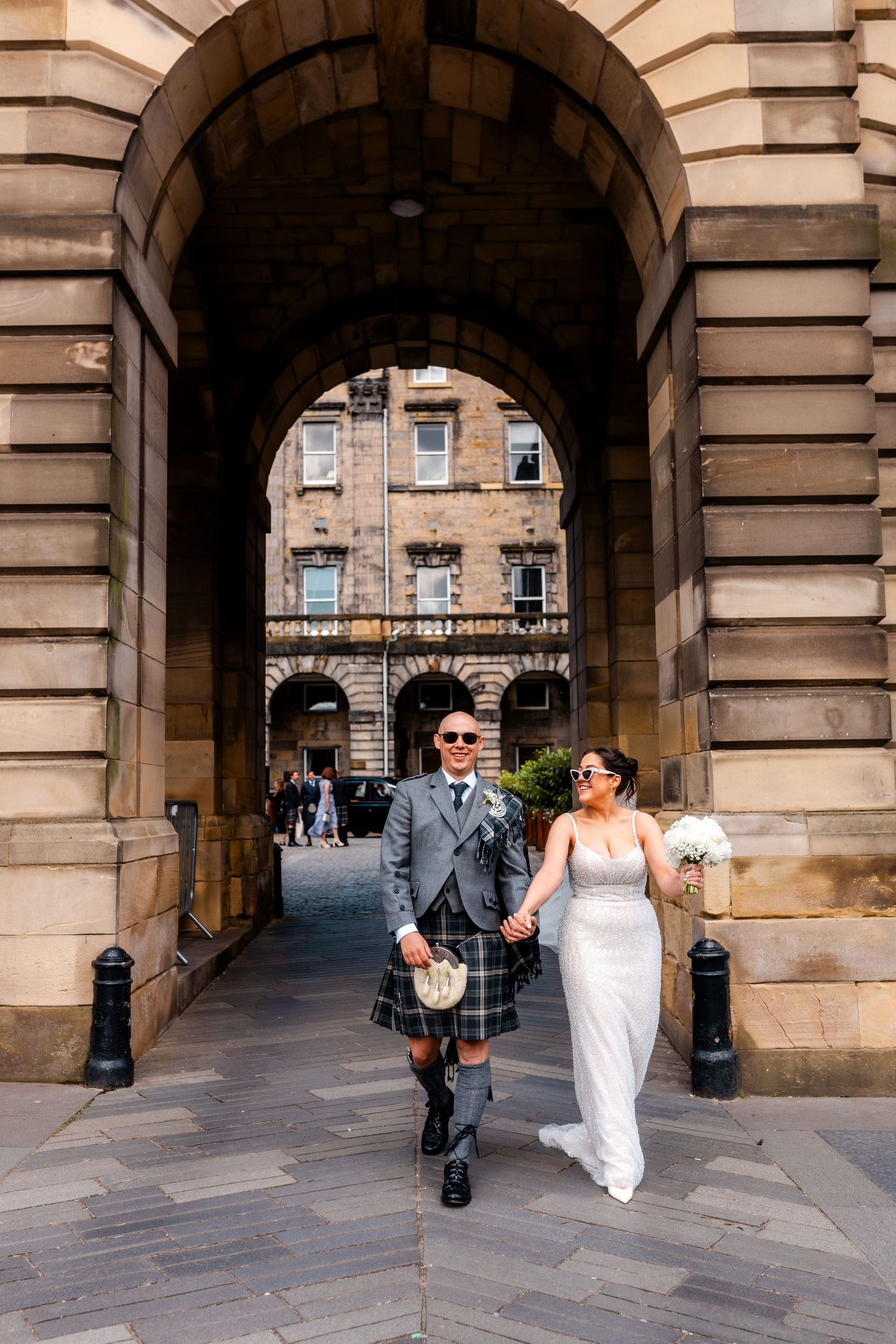 Wedding, bride and groom walking outside, City Chambers wedding in Edinburgh, Scotland,