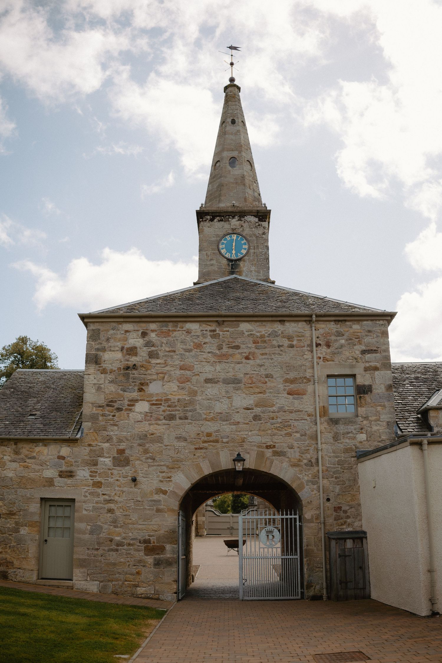 Historic stone church entrance with clock tower and archway gates photographed from multiple angles in cloudy weather.