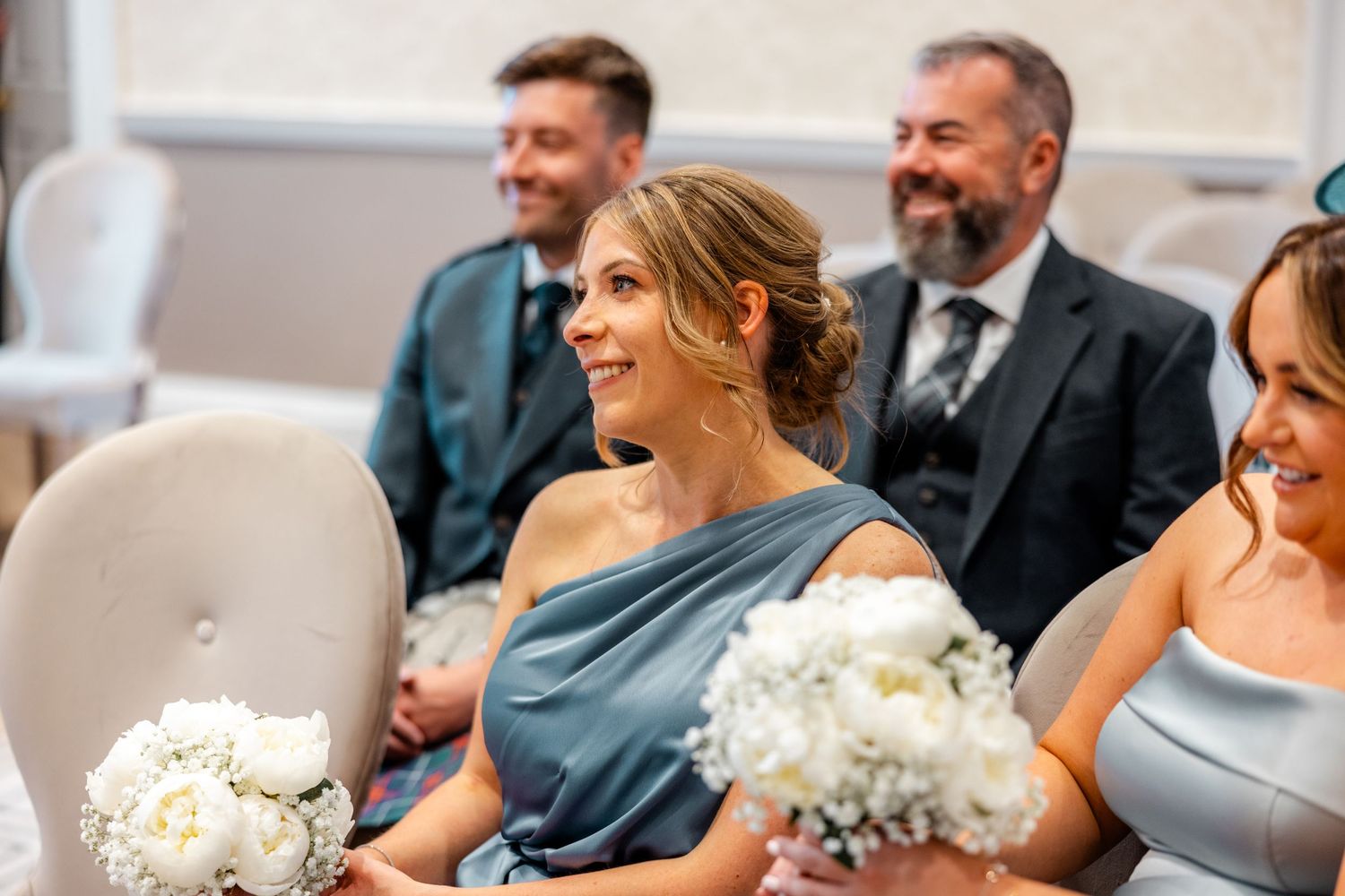 Bride's family smiling inside City Chambers wedding in Edinburgh, Scotland,