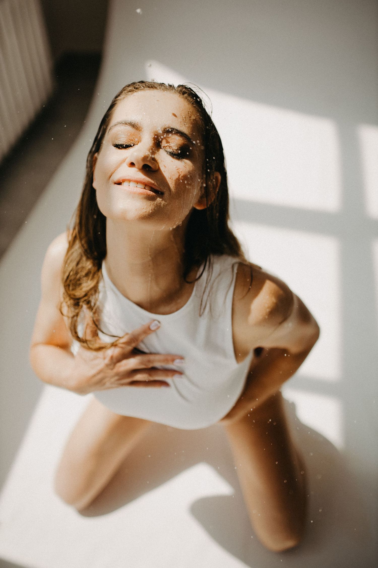 Artistic portrait with sunlight casting geometric shadows.