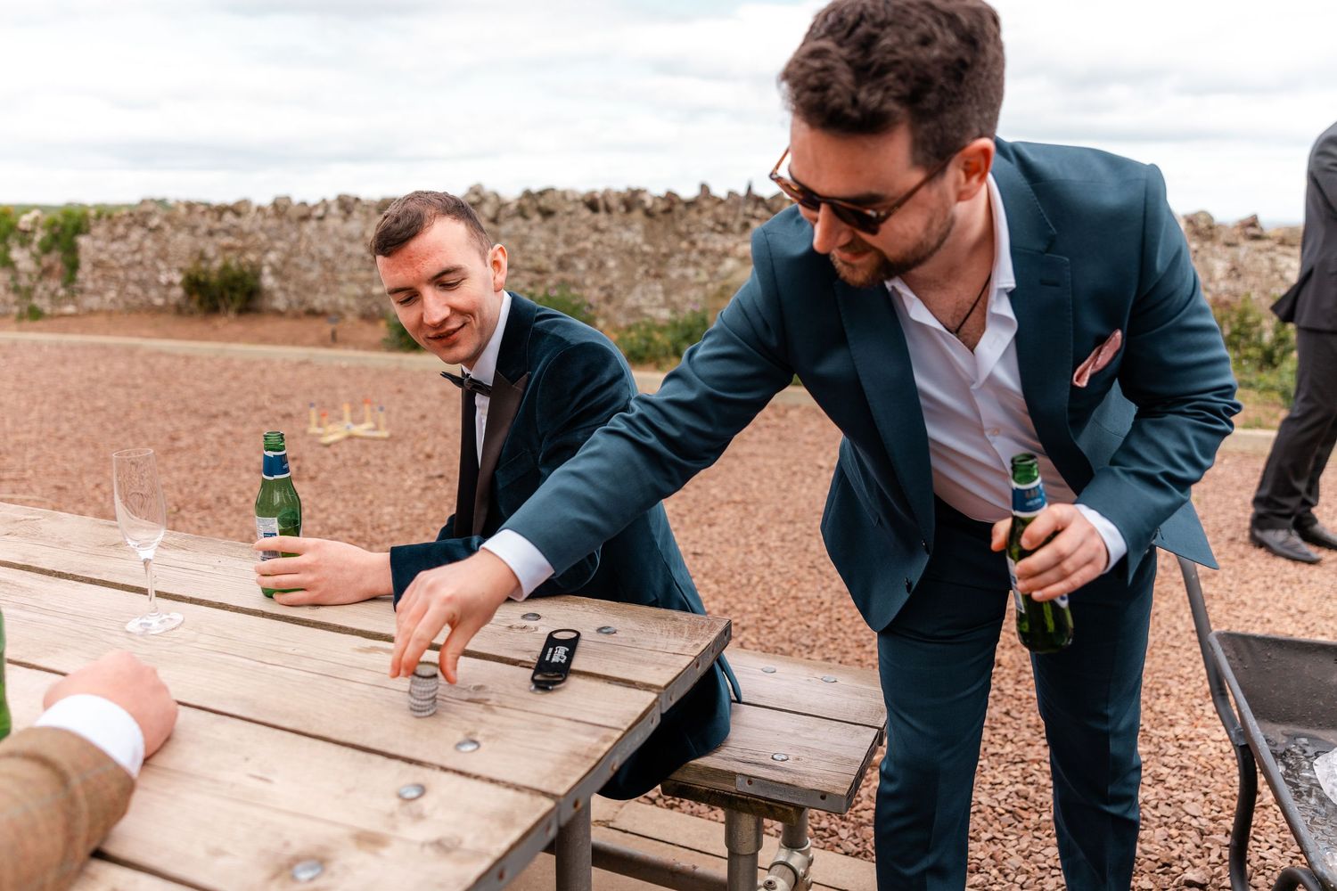 People enjoying drinks and conversation at an outdoor gathering.