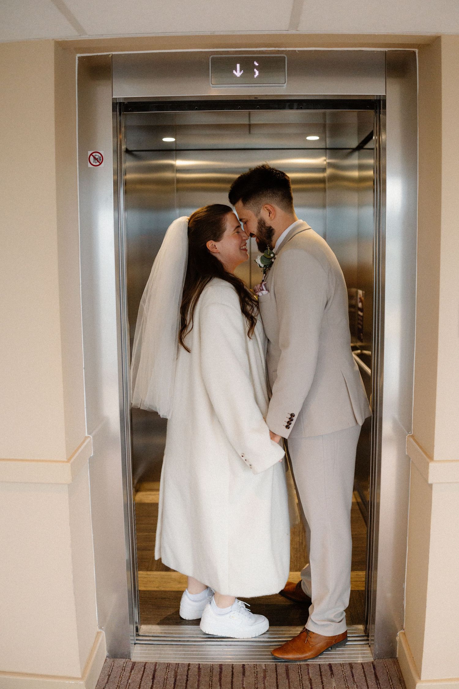 Creative wedding photo series showing couple kissing in elevator.