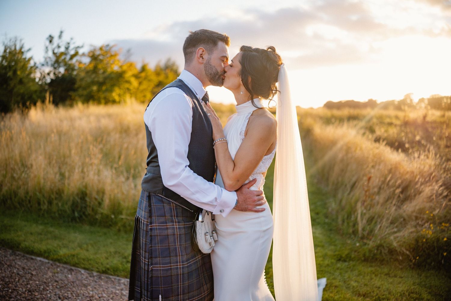 Golden Hour bride and groom kissing at Rosebery Steading, Temple, Gorebridge, Scotland.