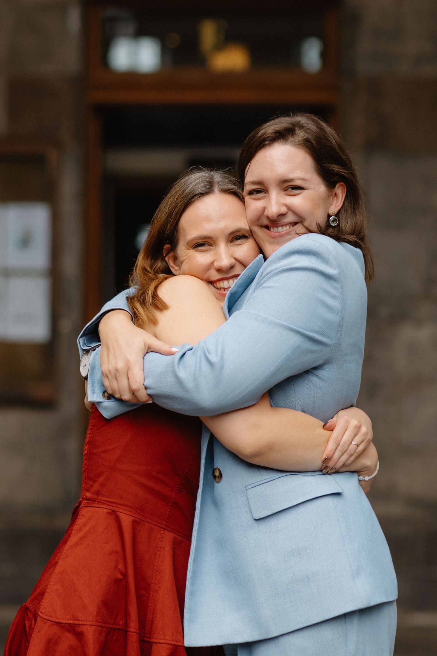 outside the Edinburgh City Chambers Edinburgh City Wedding photo bride hugging friend
