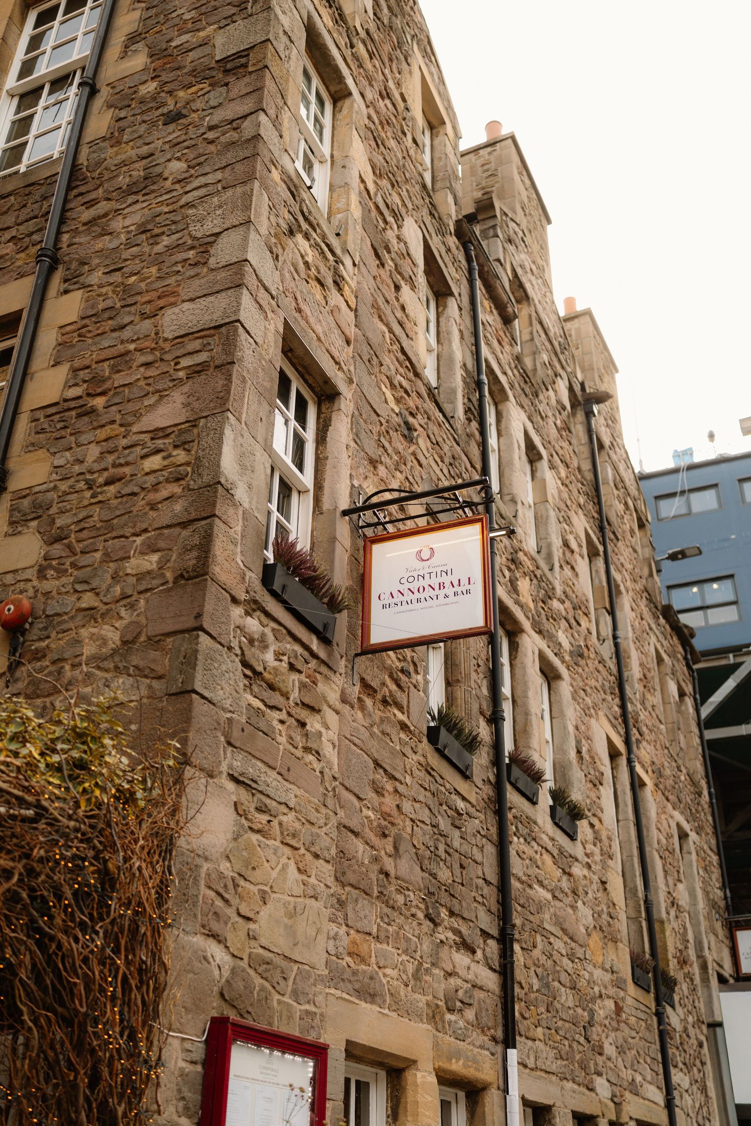 Historic stone building with Cannonball Restaurant and Bar sign on Edinburgh Royal Mile.