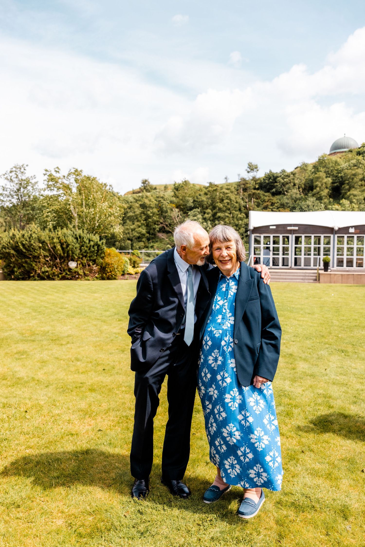 Old couple grandparents outside of Glass house Edinburgh, Scotland.