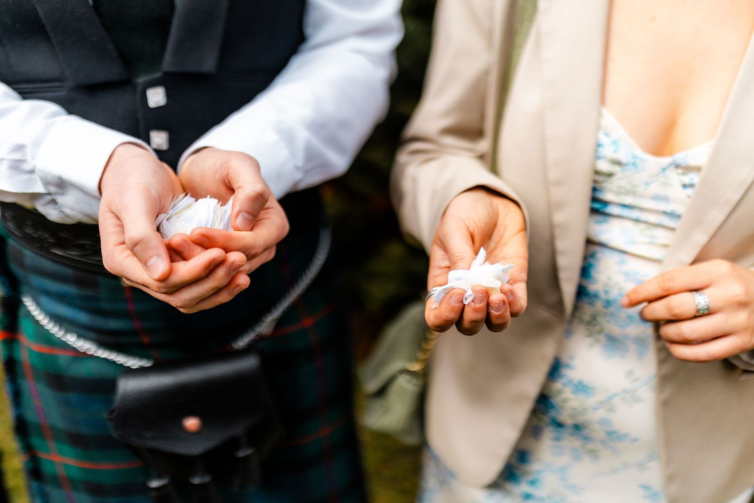 Close-up shots of hands holding confetti and rose petals at a wedding.