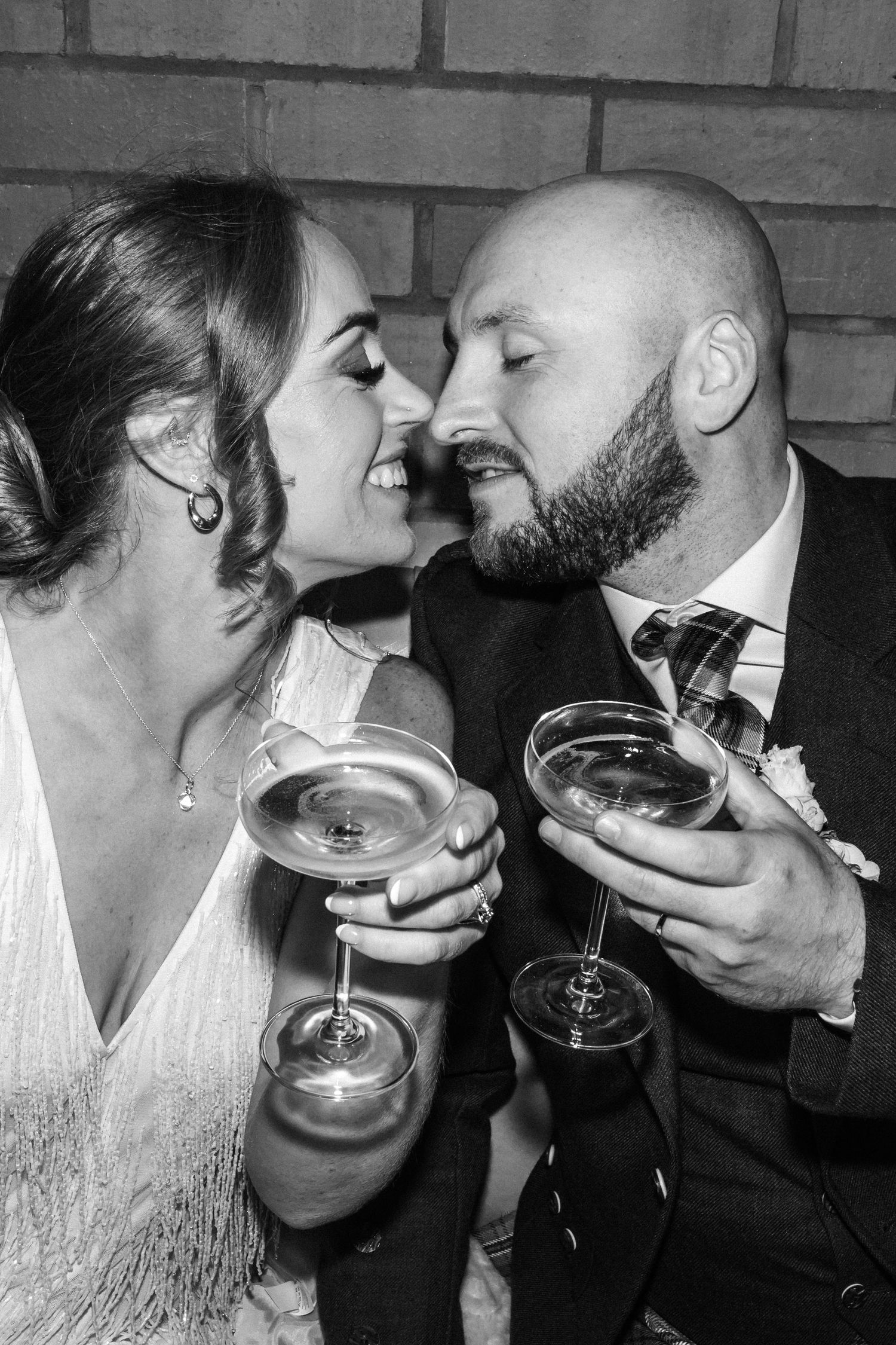 Two people in formal attire sharing champagne glasses in a romantic black and white photo sequence.