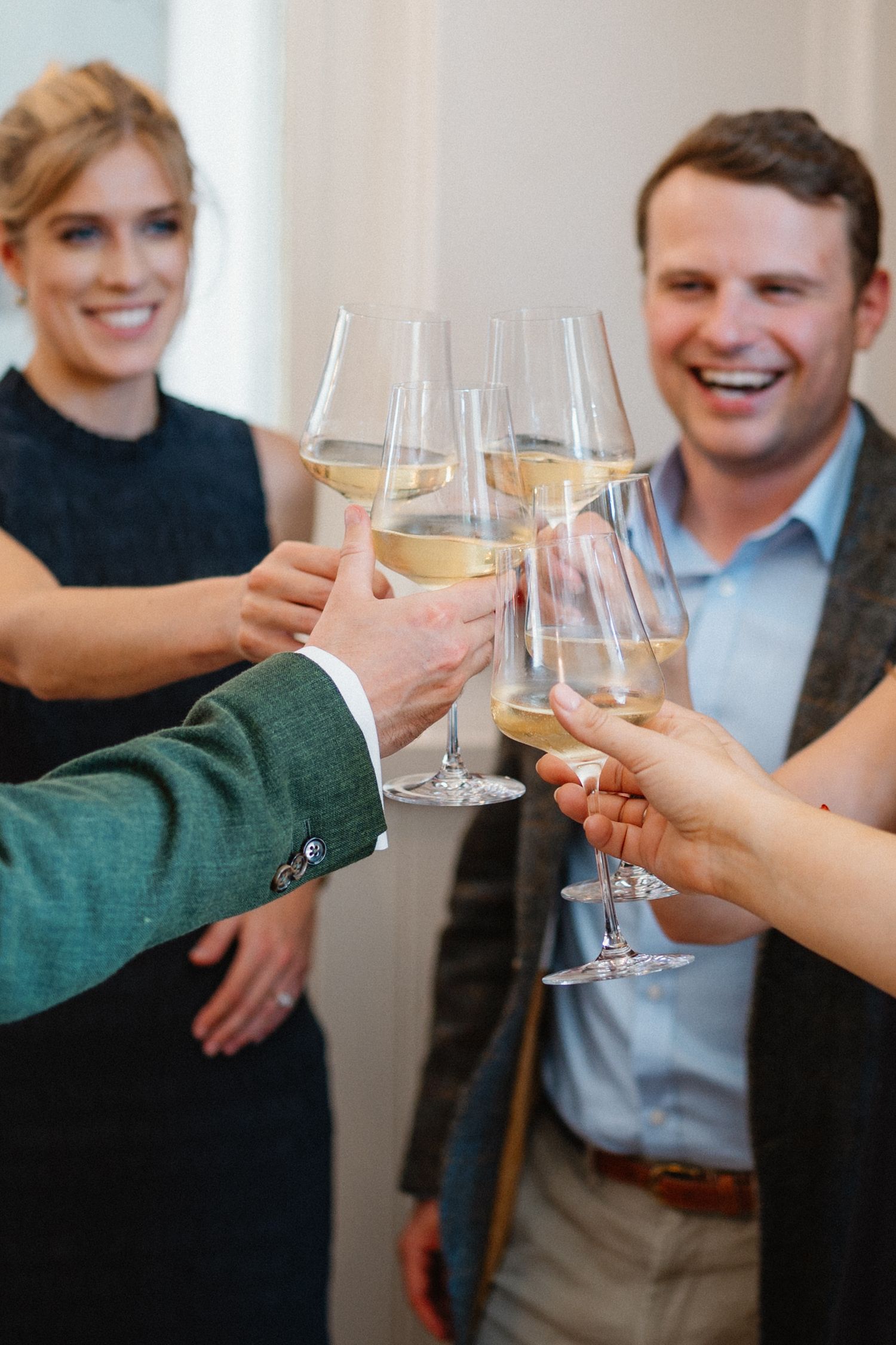 Wedding guests toasting with champagne glasses during a celebration.