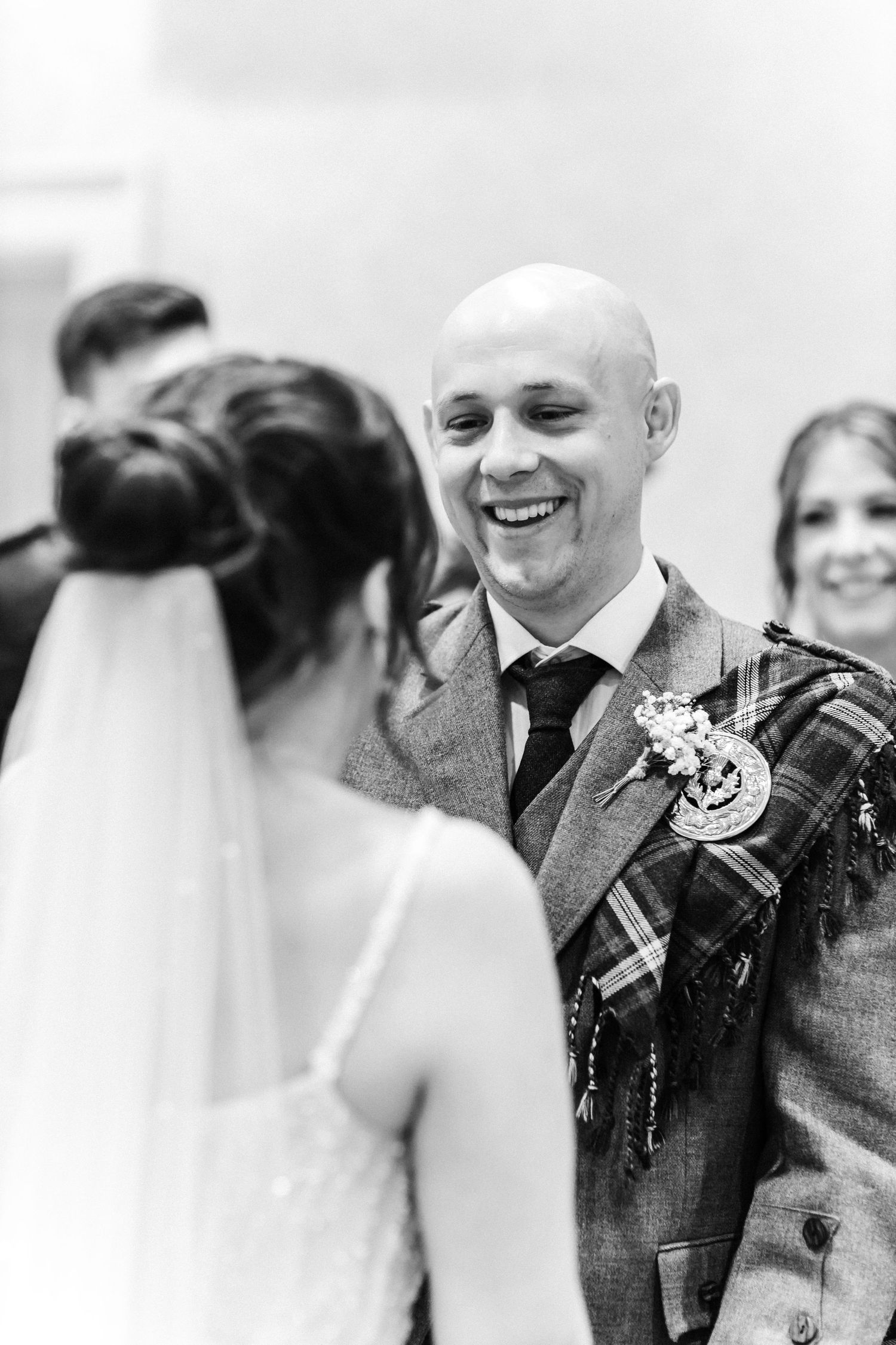 Groom looking and smiling at the bride, City Chambers wedding in Edinburgh, Scotland,