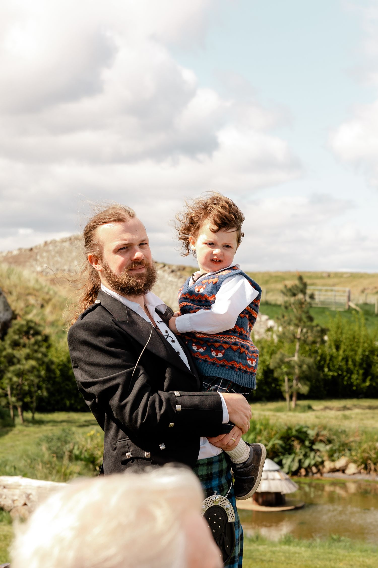A heartwarming moment shared between two people against a scenic countryside backdrop.