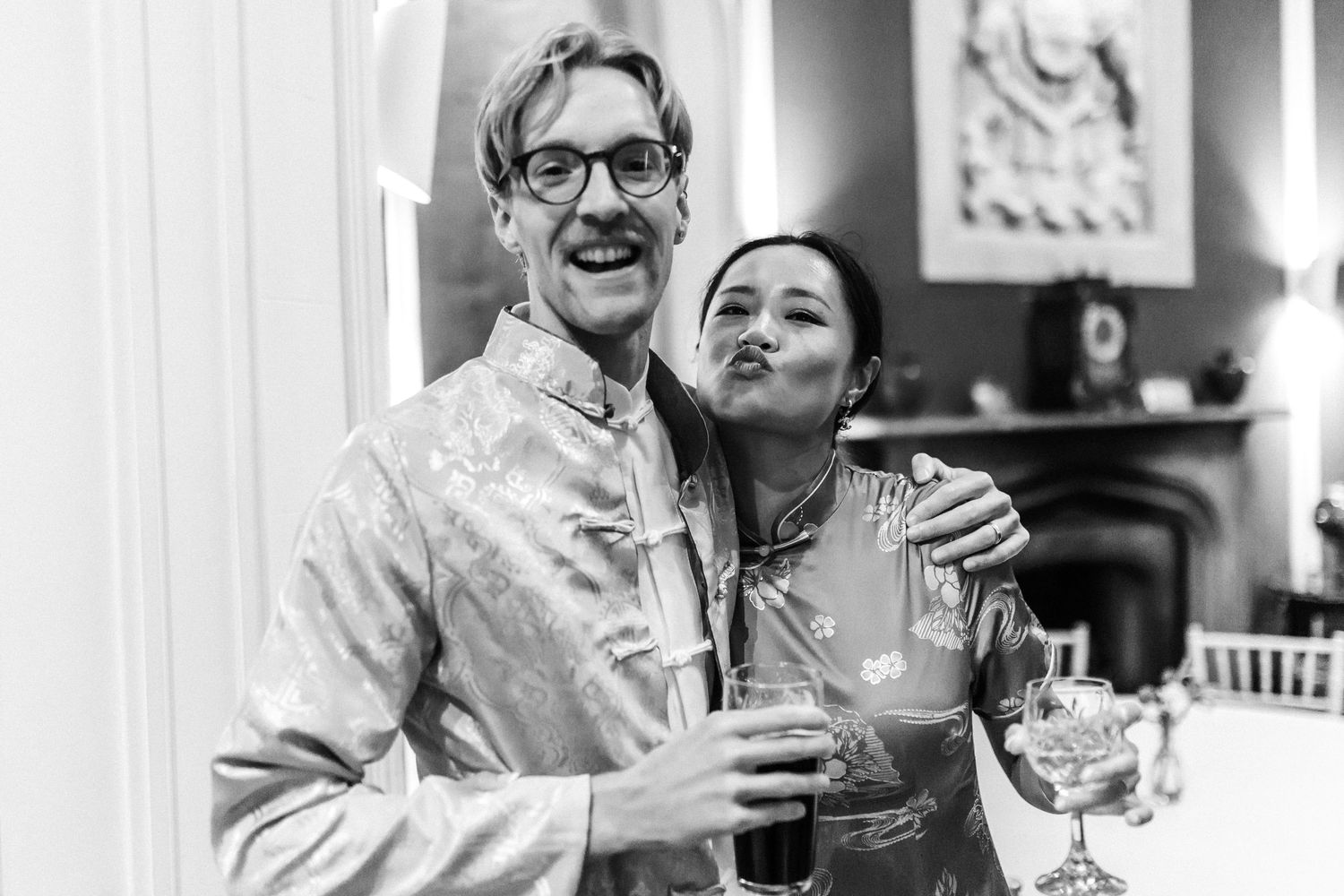 Guests sharing drinks and laughter at an elegant indoor celebration.