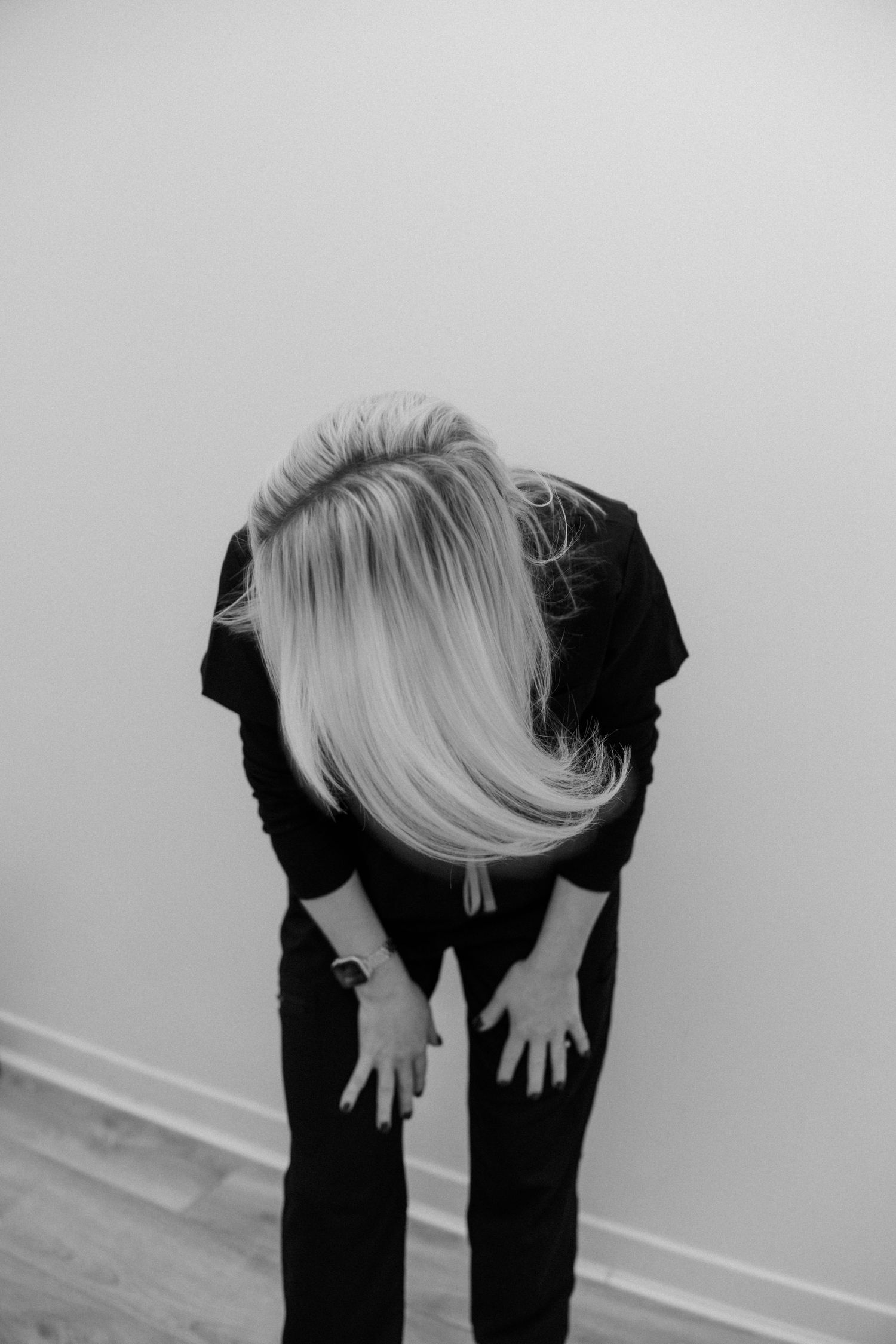 Artistic black and white shot showing silhouette bending forward.