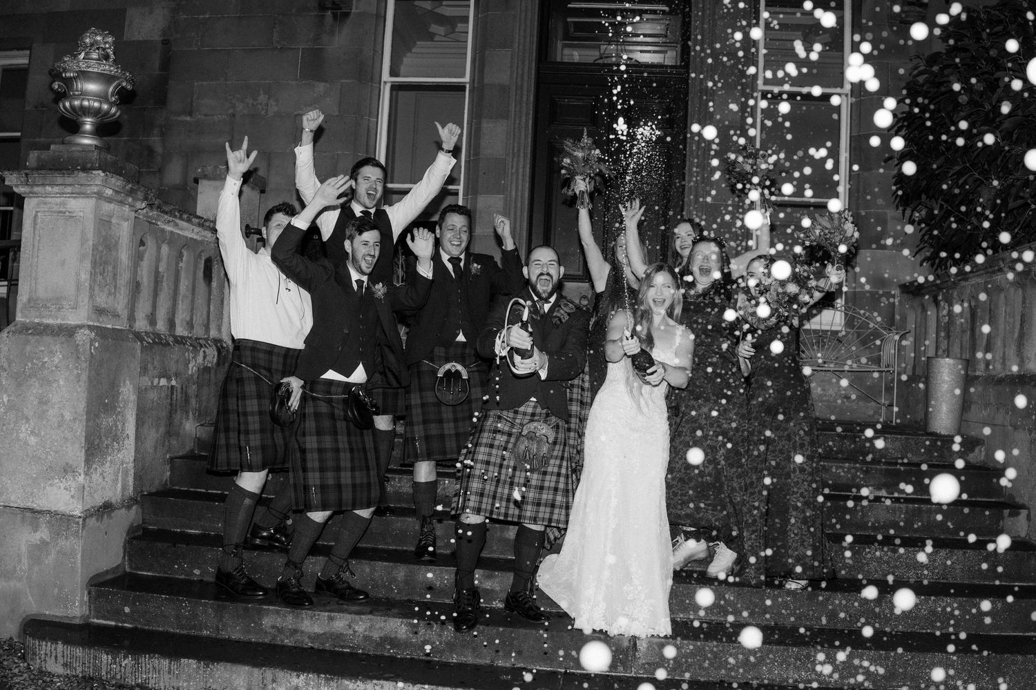 Black and white photo sequence of wedding guests celebrating with sparklers at night.