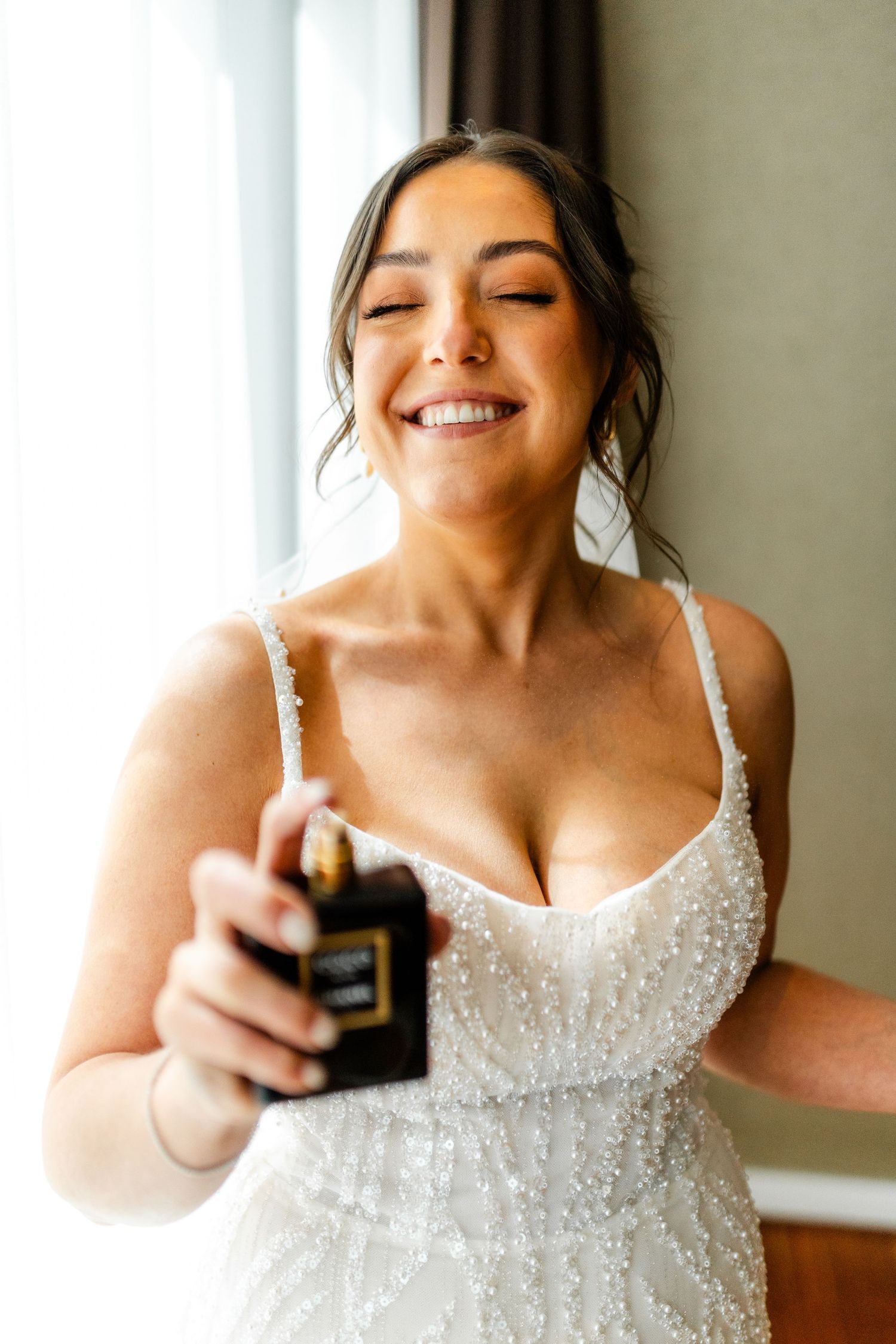 Bride putting perfumes on, getting ready, Glass House Edinburgh, Scotland,