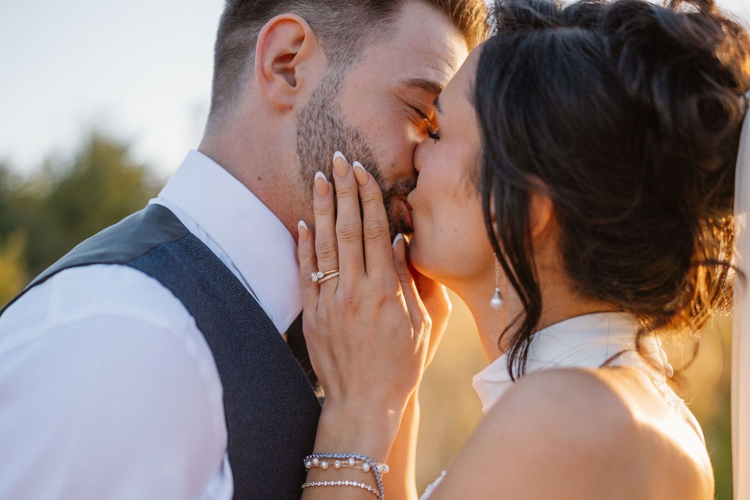 Intimate romantic moments captured during sunset wedding photography session.