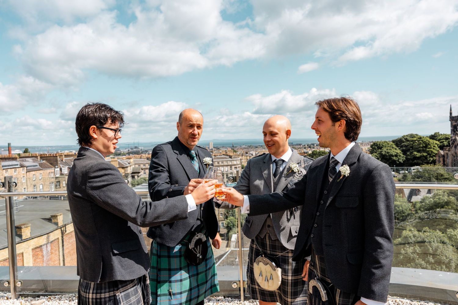 Grooms party having drink on the tarace, Glass House Edinburgh, Scotland,