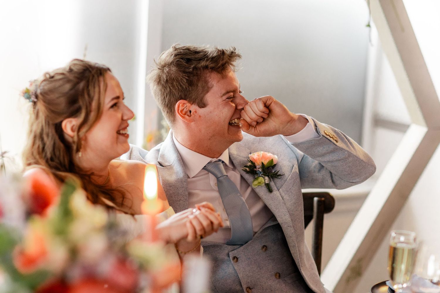 Candid moments of celebration at an elegant wedding reception dinner.
