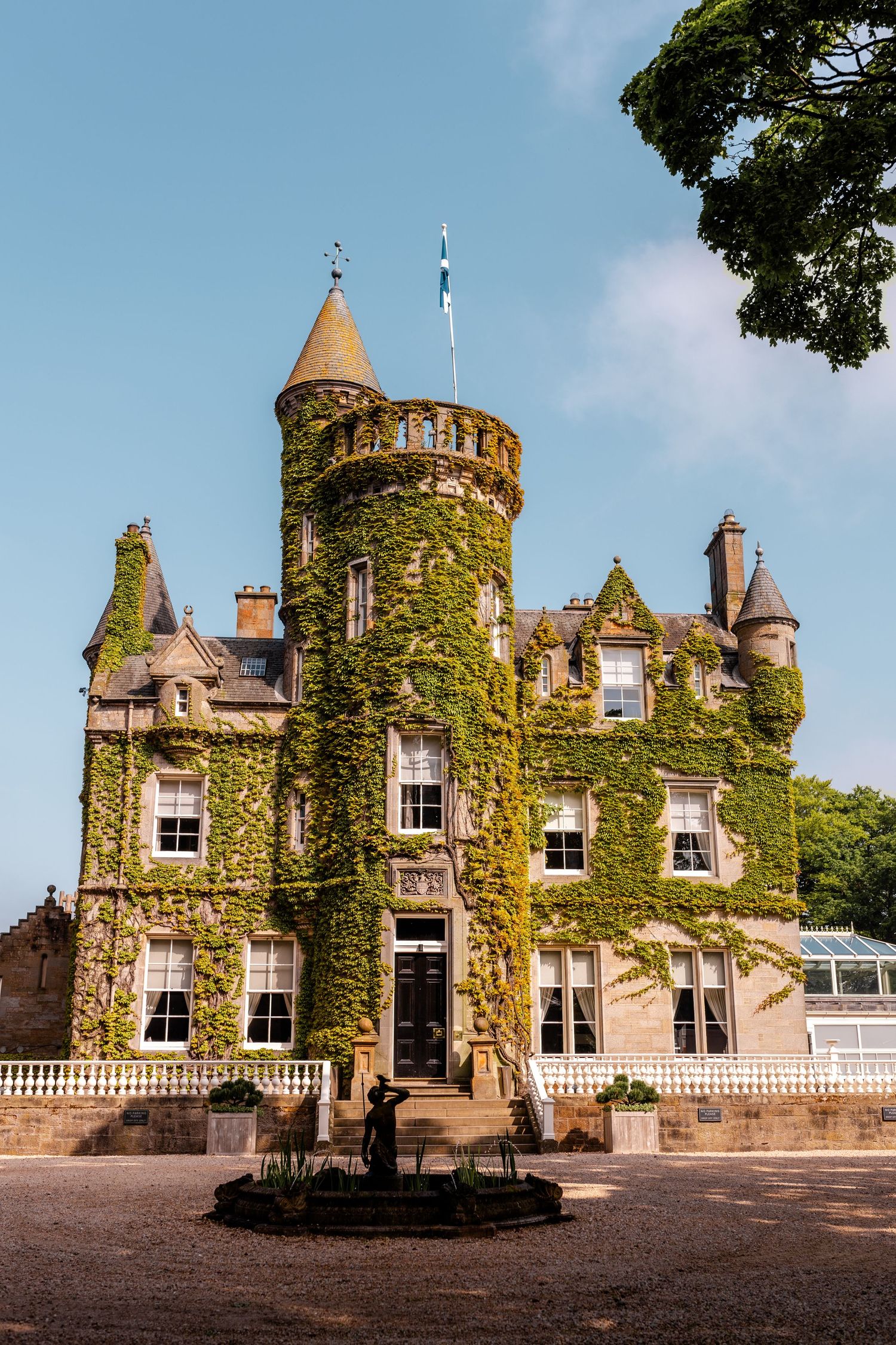 Historic ivy-covered castle-like building with turrets and stone architecture shown from multiple angles.