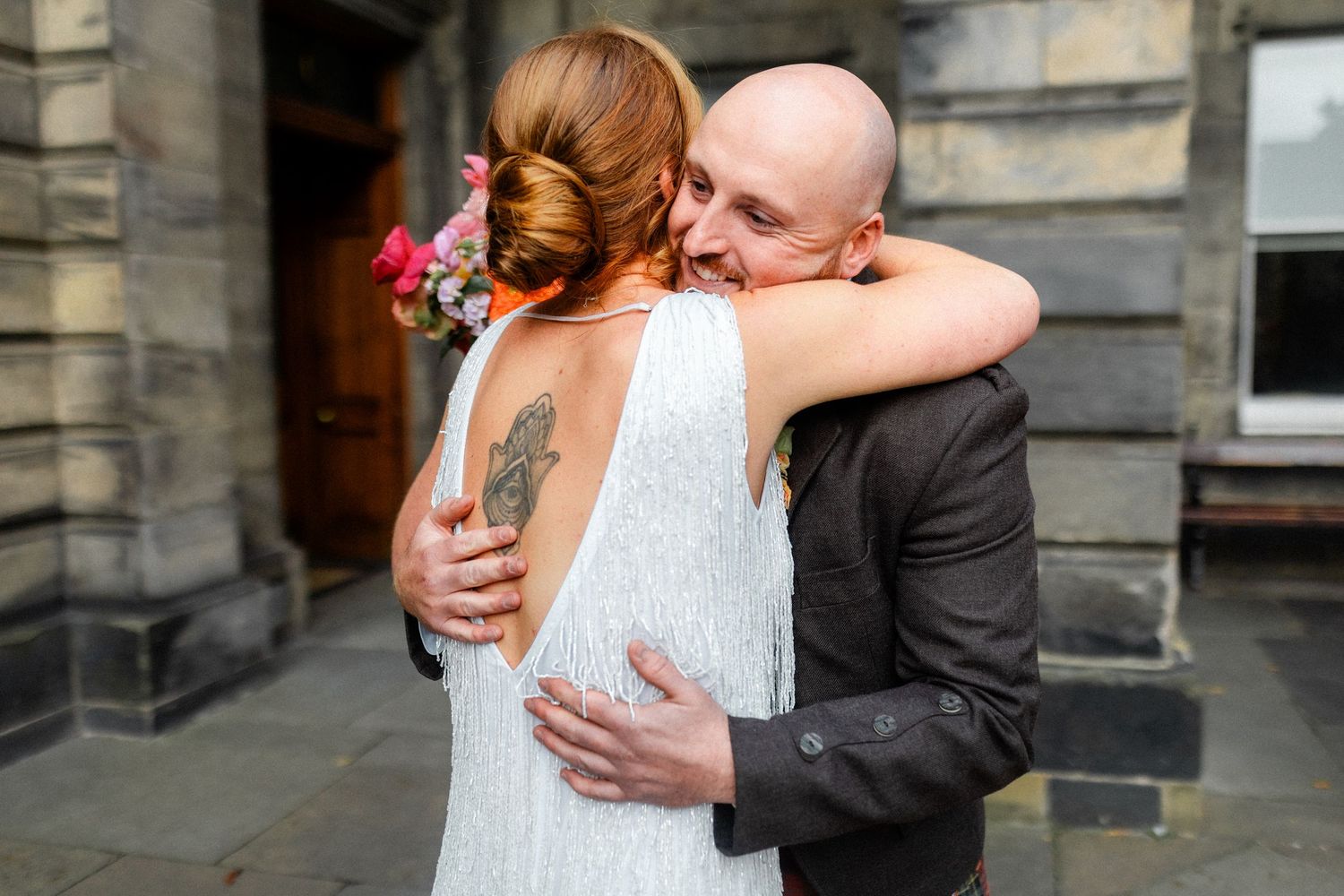 Emotional first look moment between couple at traditional Scottish wedding venue.