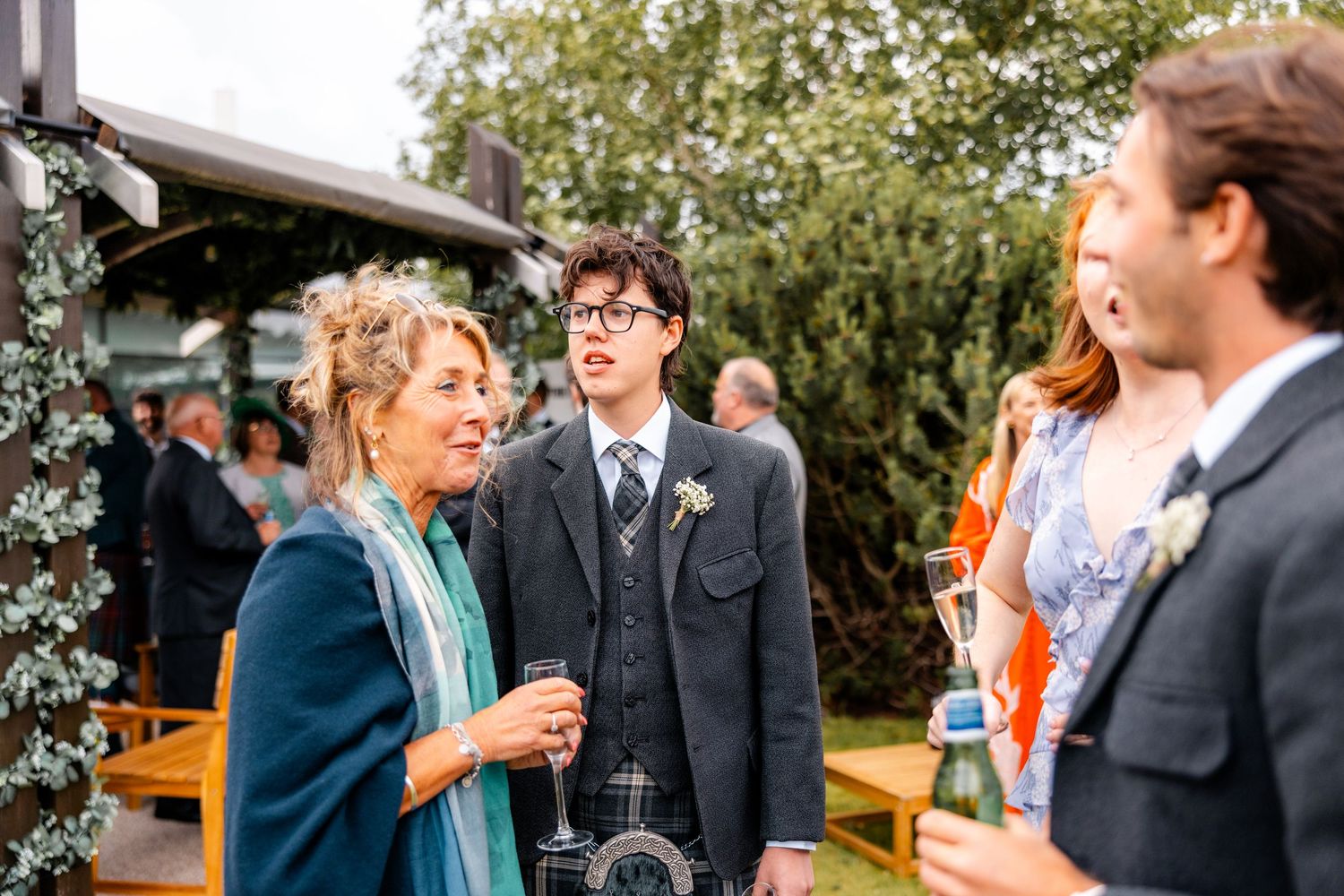 Family talking wedding outside of the Glass House, Edinburgh, Scotland.