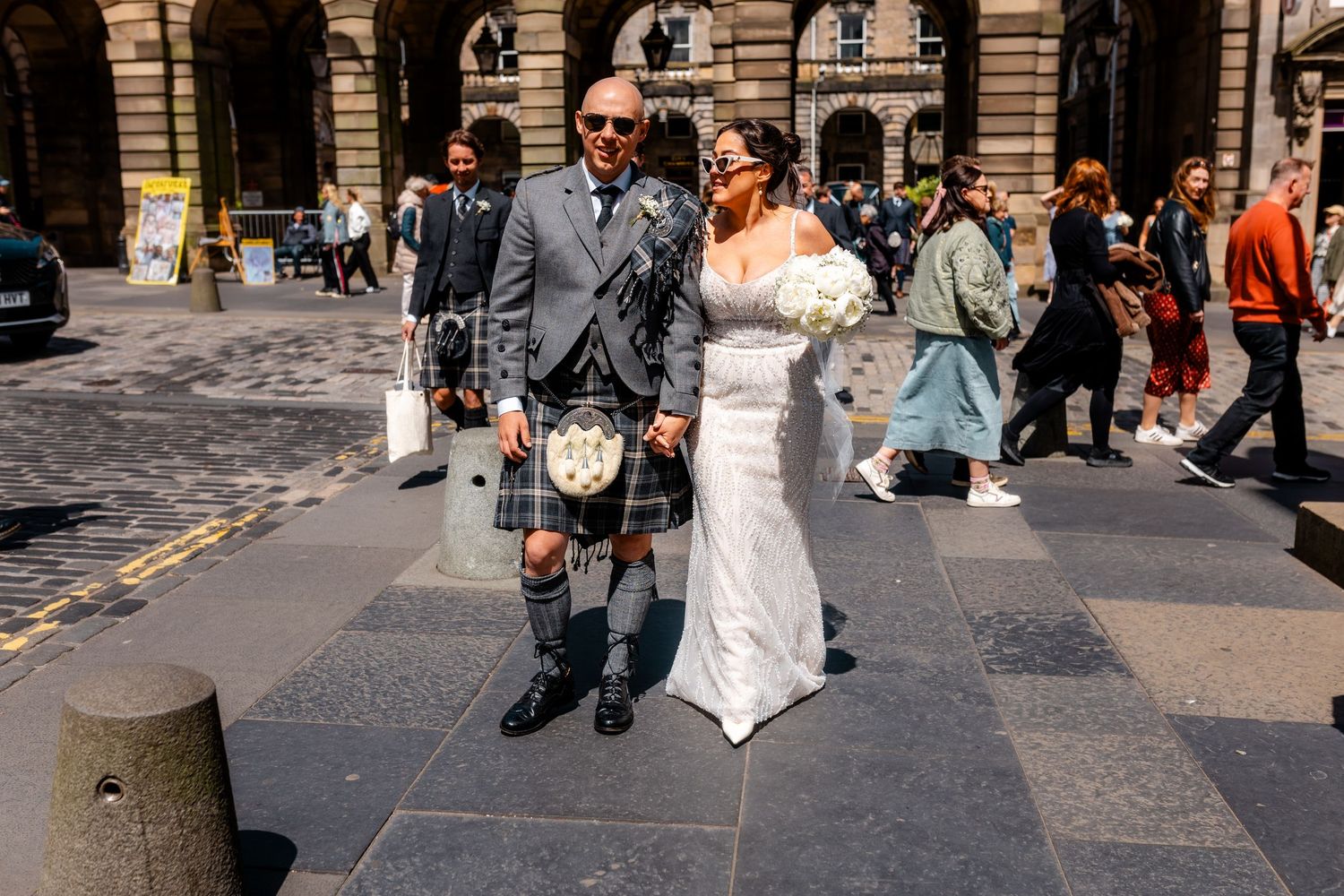 Wedding, bride and groom walking Streets, City Chambers wedding in Edinburgh, Scotland,
