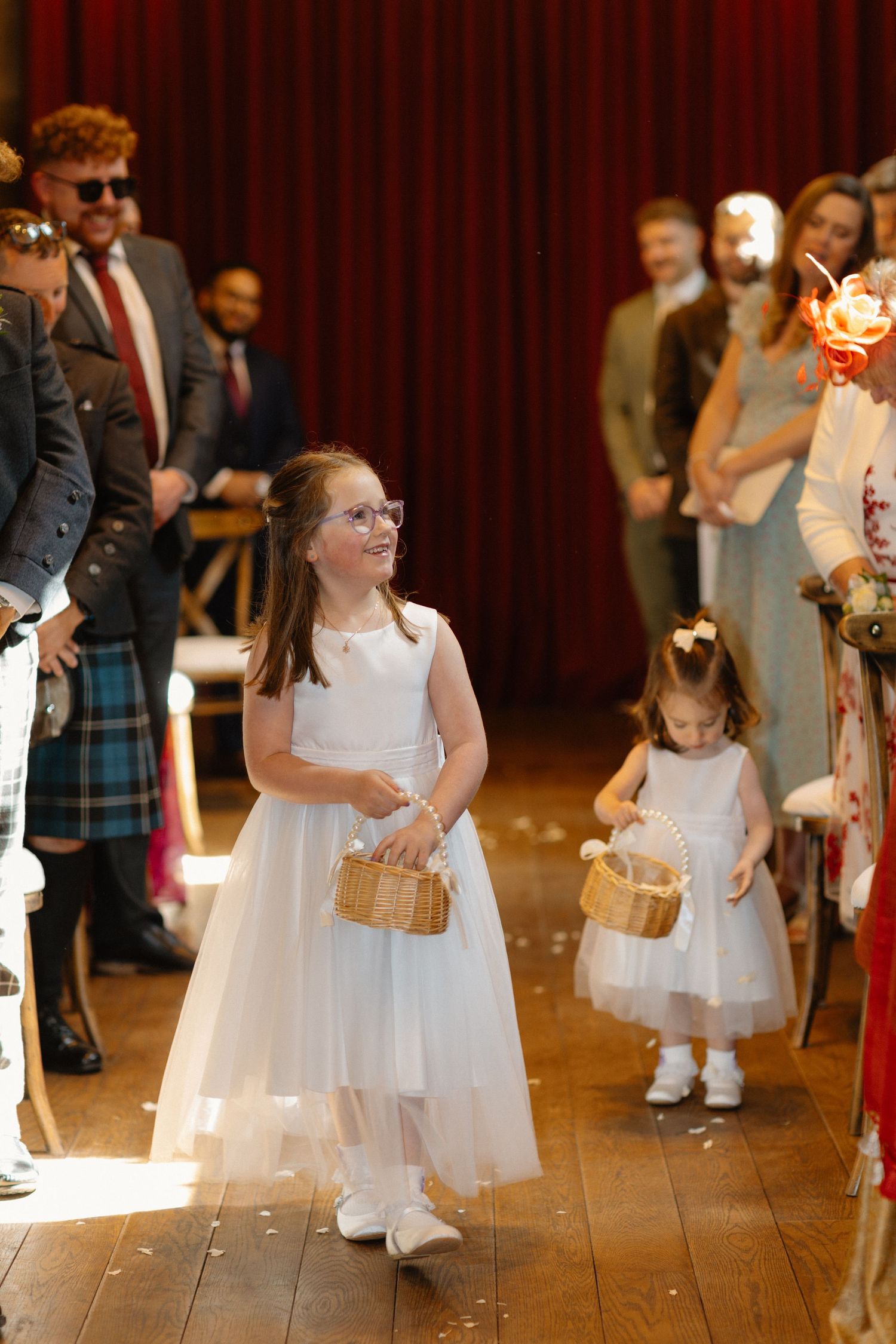 Wedding ceremony, kids walking down the isle, at Rosebery Steading, Temple, Gorebridge, Scotland.