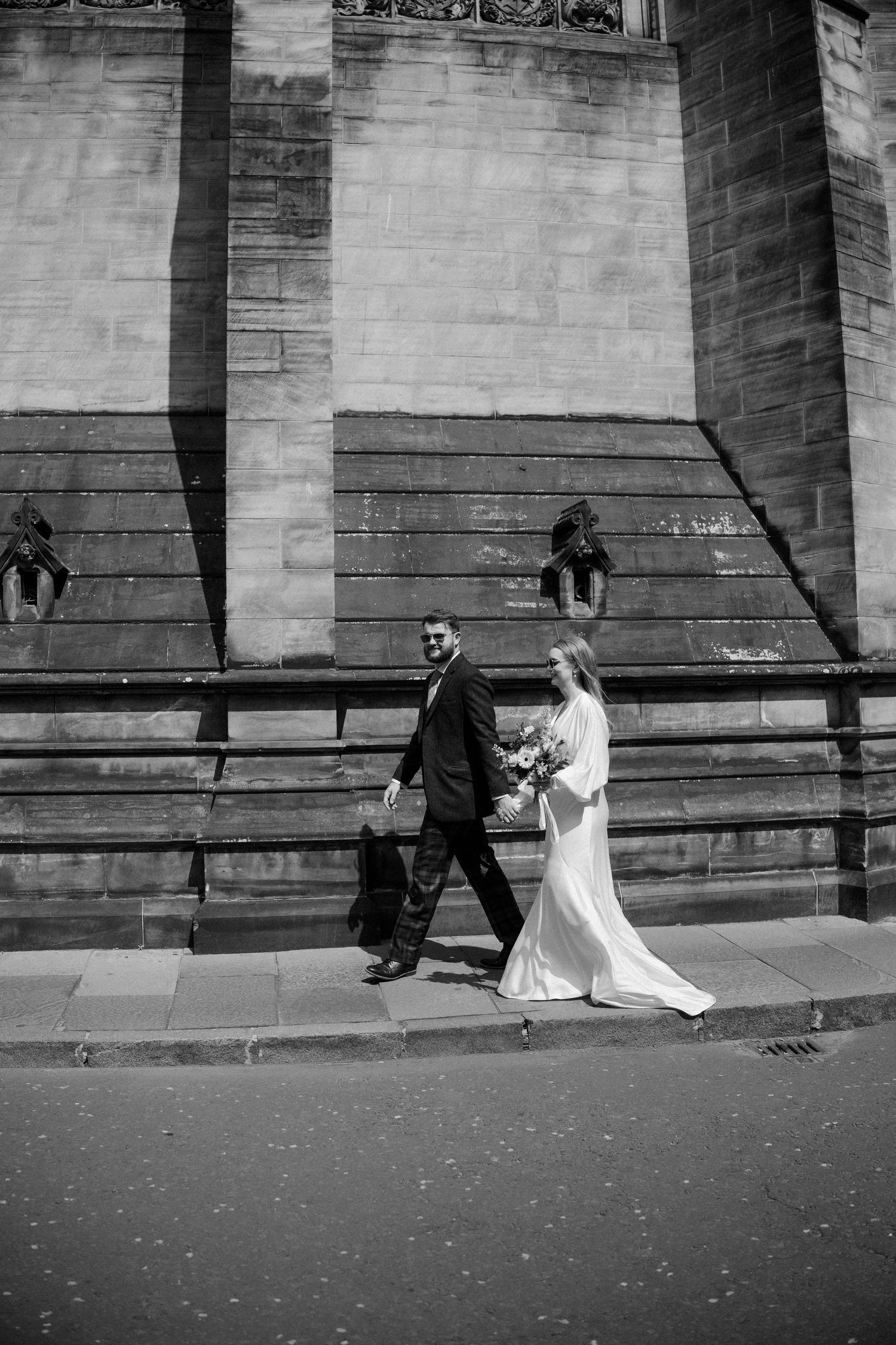 Bride and groom walking around the city  in Edinburgh Scotland