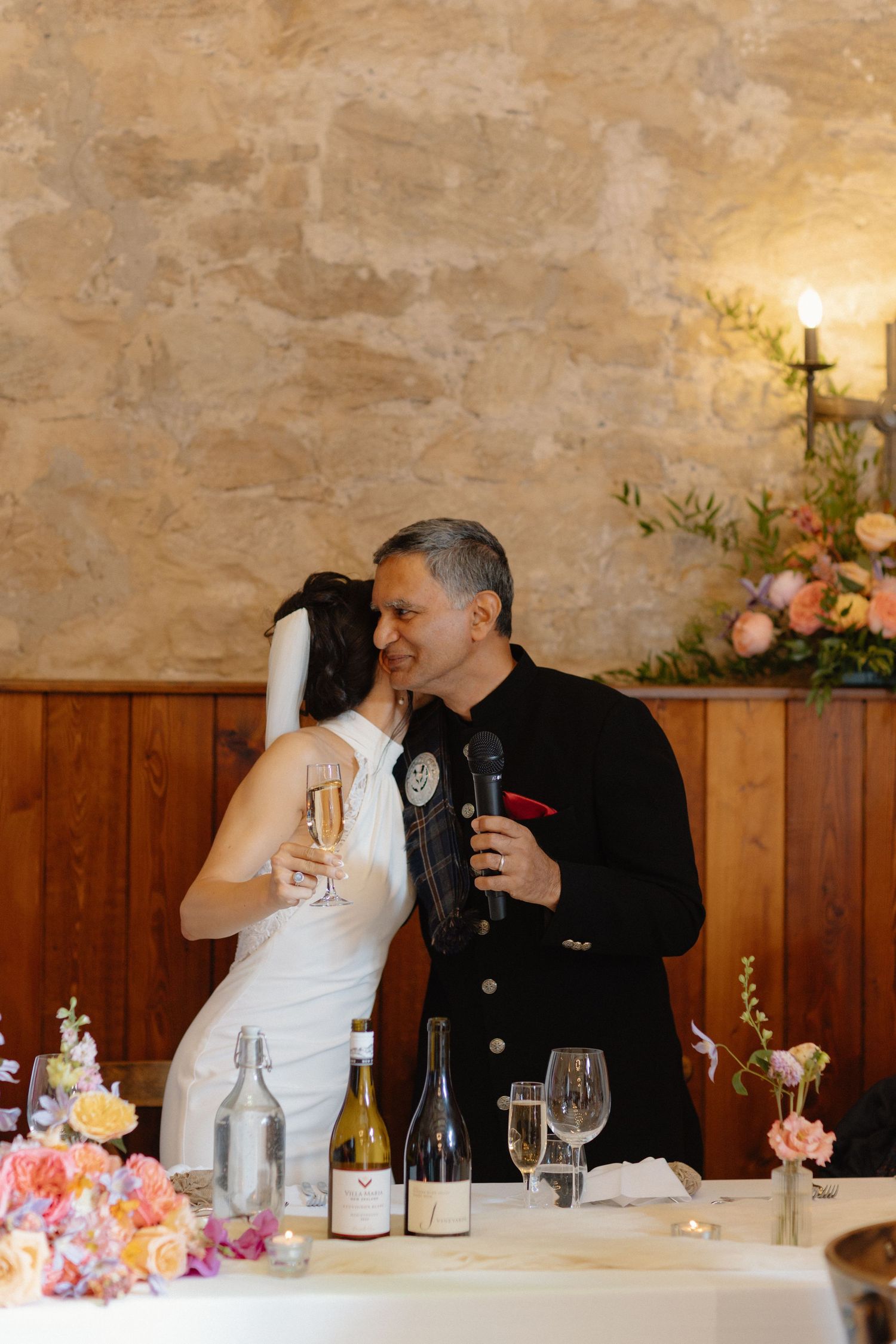 Bride with Dad hugging, wedding speeches at Rosebery Steading, Temple, Gorebridge, Scotland.