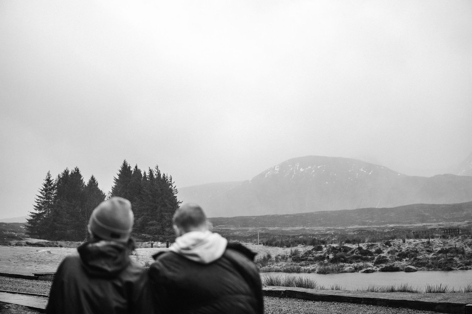 A scenic mountain landscape with rolling hills and evergreen trees in the distance.