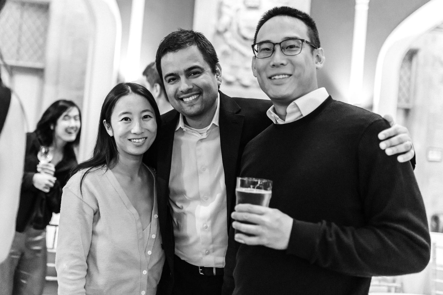 Group of people smiling and celebrating in a bright indoor space.