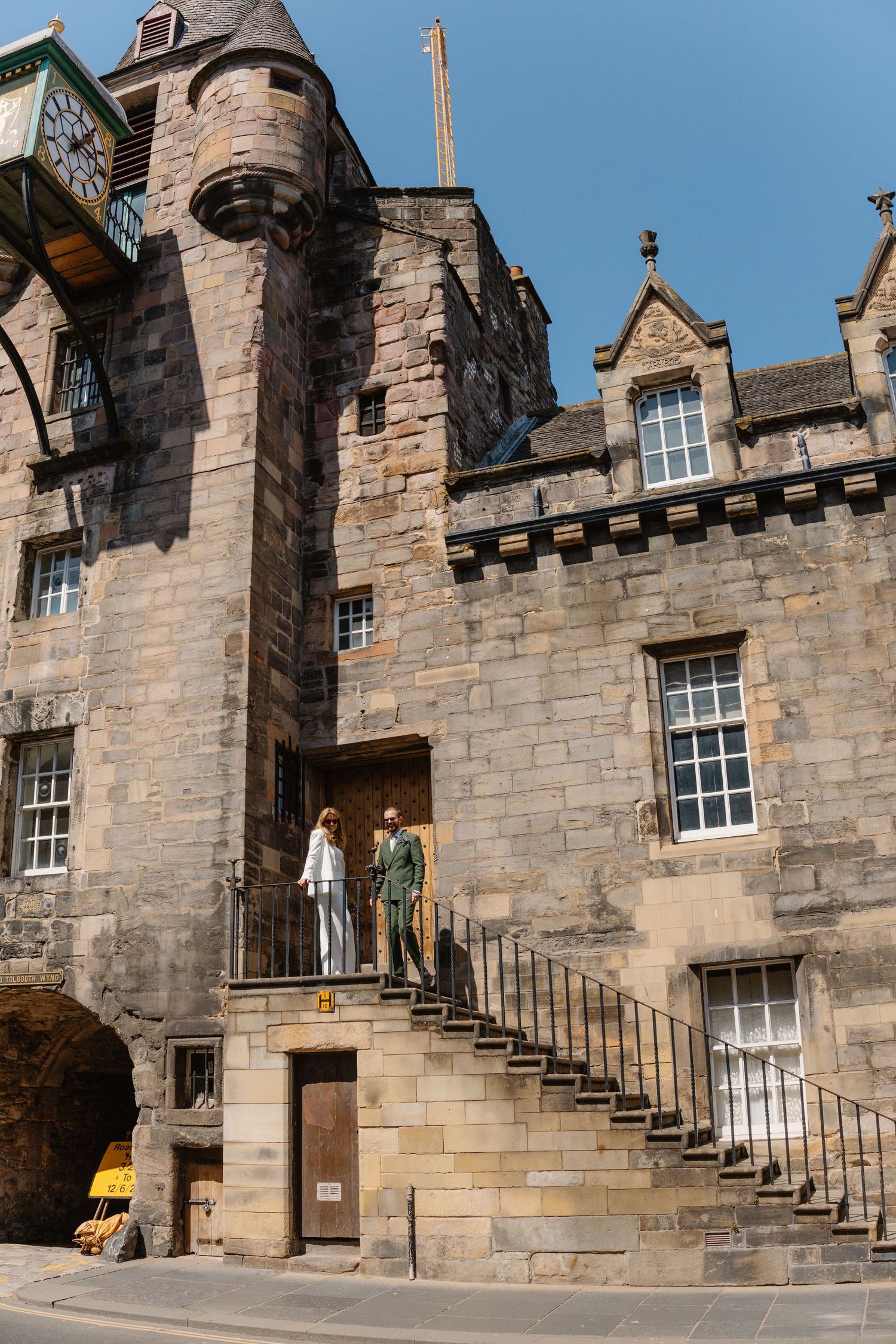 Stone staircase and architectural details of a historic castle building with windows and turrets.