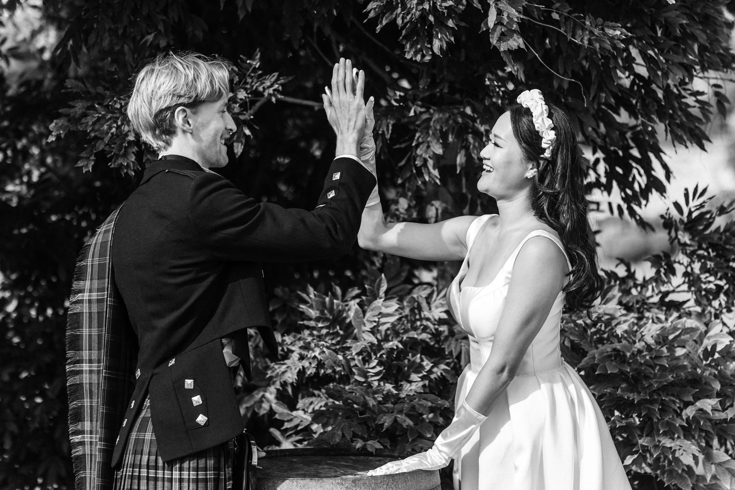 Black and white wedding photography sequence in outdoor setting.