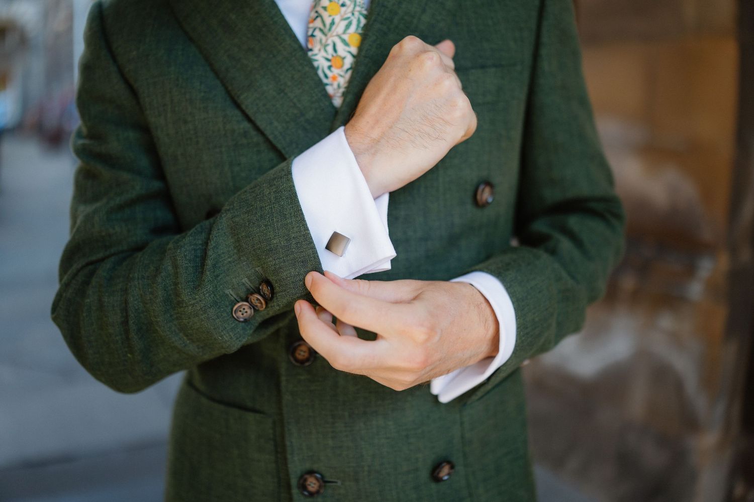 Detail shots of formal attire showing cufflinks and jacket buttons.