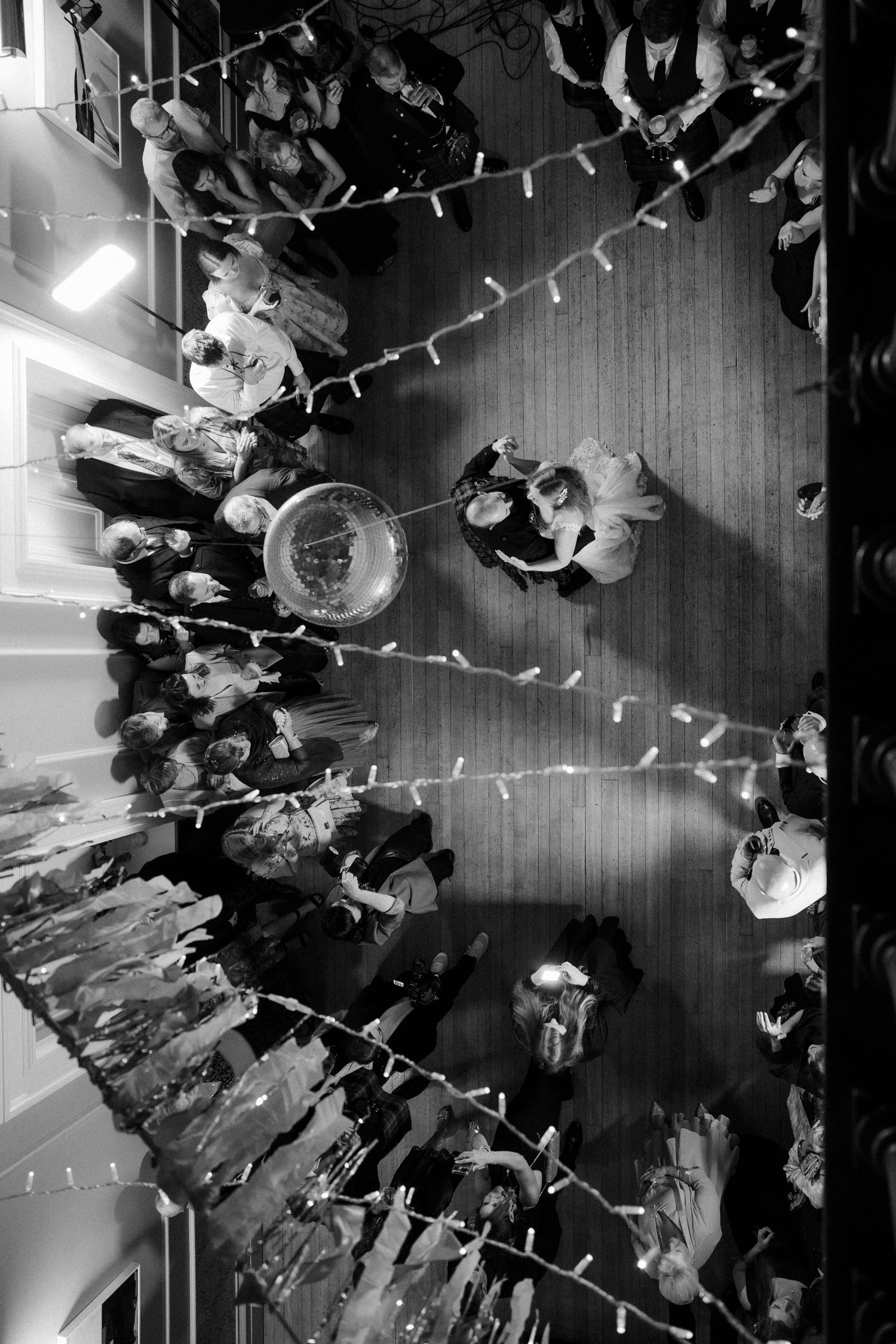 Aerial view of wedding reception dance floor with string lights overhead.