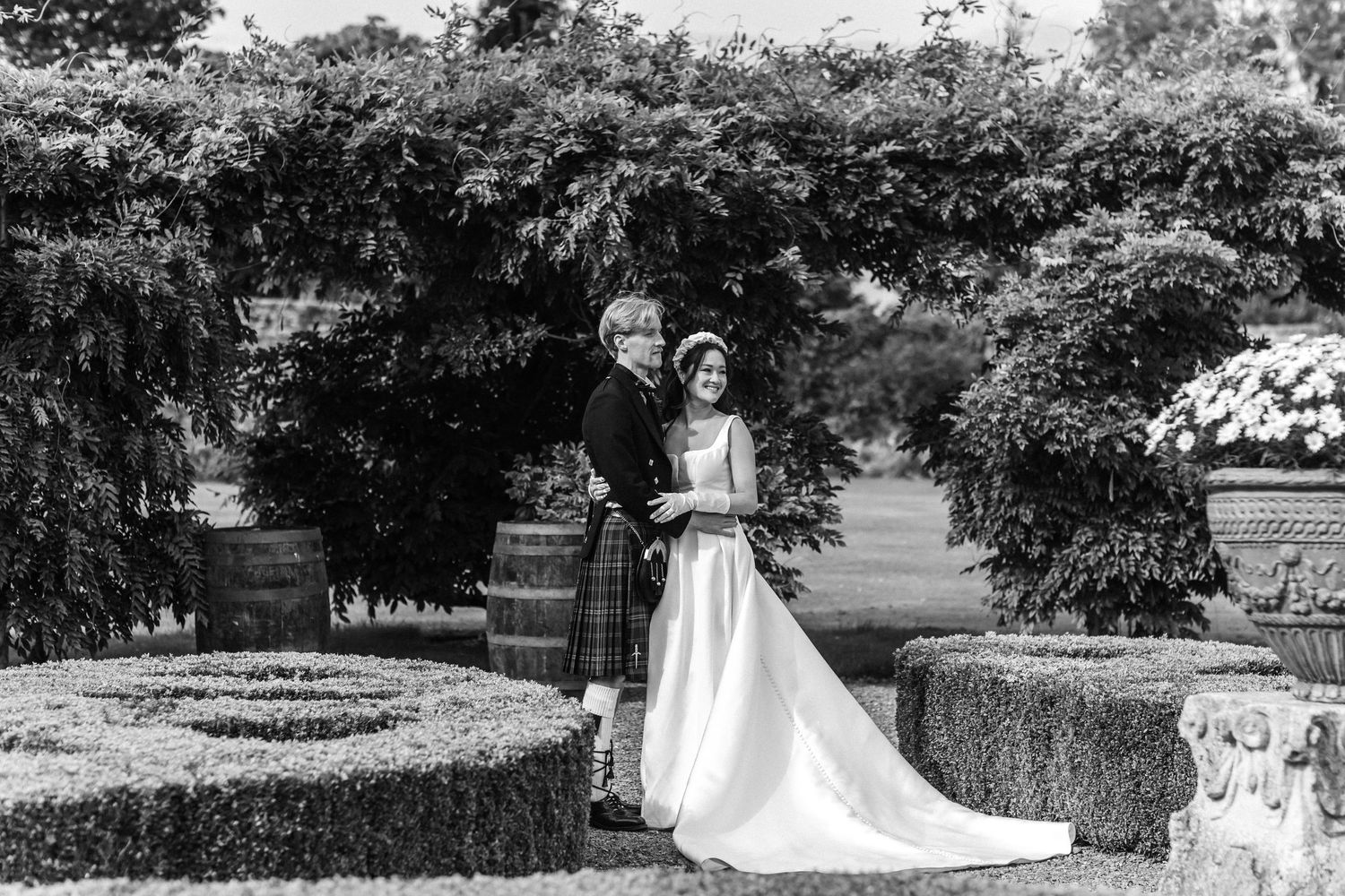 Elegant garden wedding venue with manicured lawns and decorative landscaping.