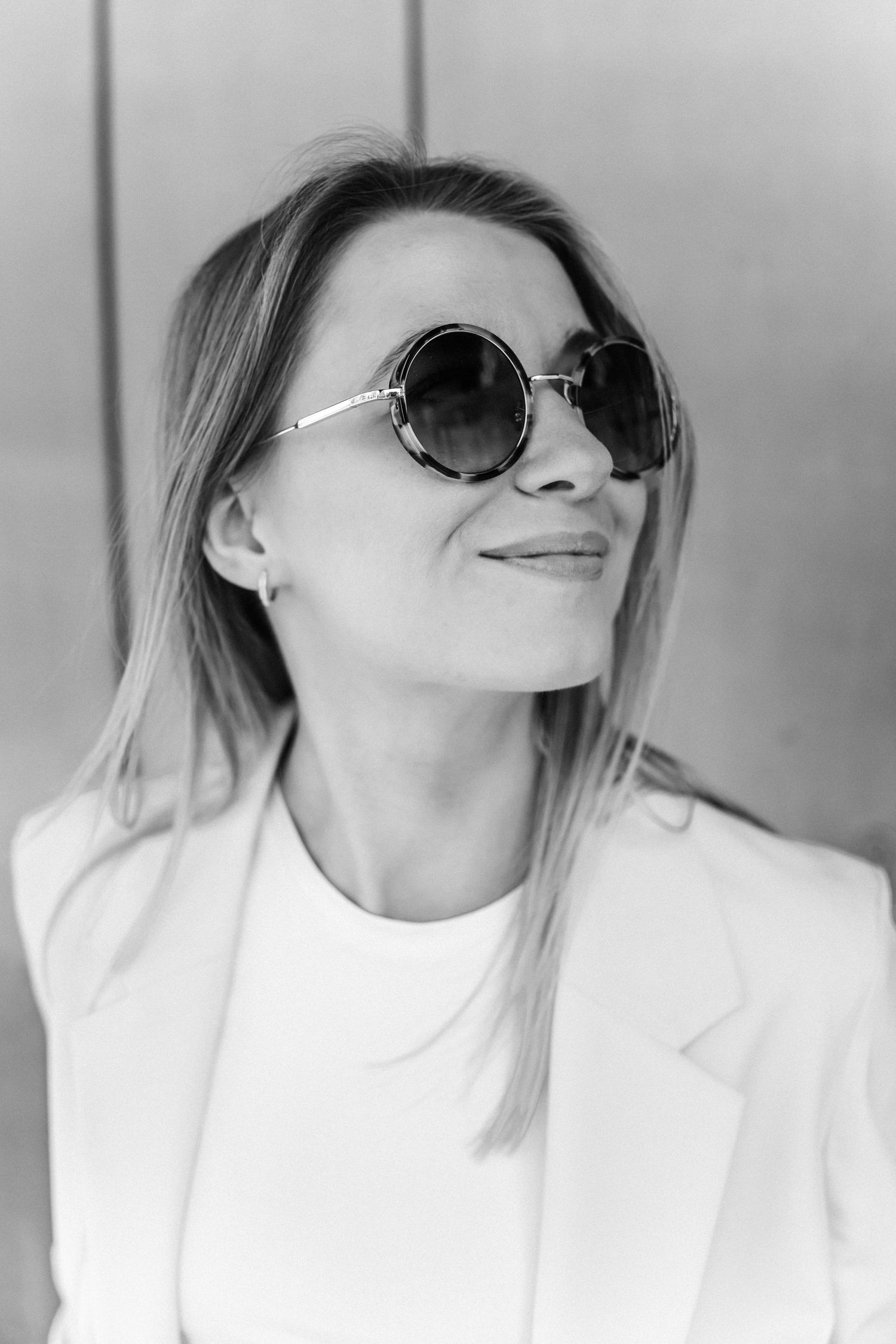 Artistic black and white portrait series featuring sunglasses and white clothing.