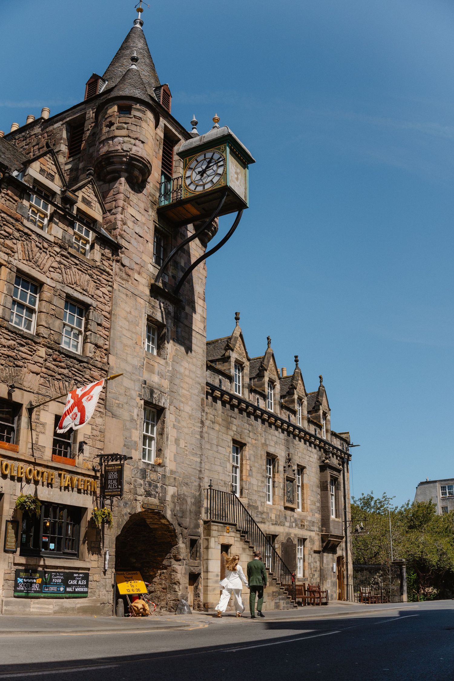 Historic stone architecture of Edinburgh with gothic details against blue sky.