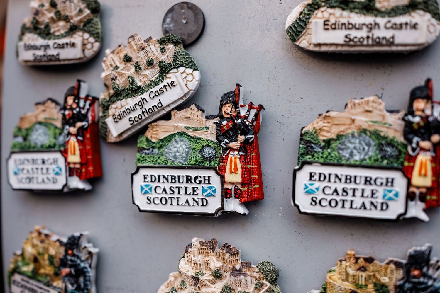 Decorative souvenir magnets featuring Edinburgh Castle and Scottish cultural imagery.
