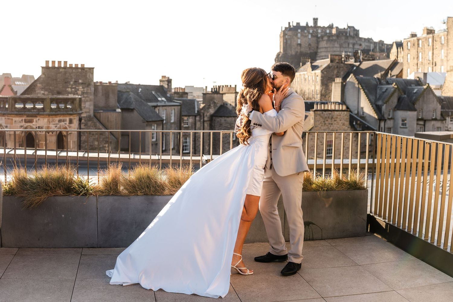 Romantic rooftop photoshoot with Edinburgh's historic skyline in the background.