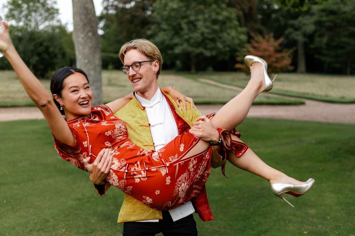Playful dancing and celebration poses on a green lawn.