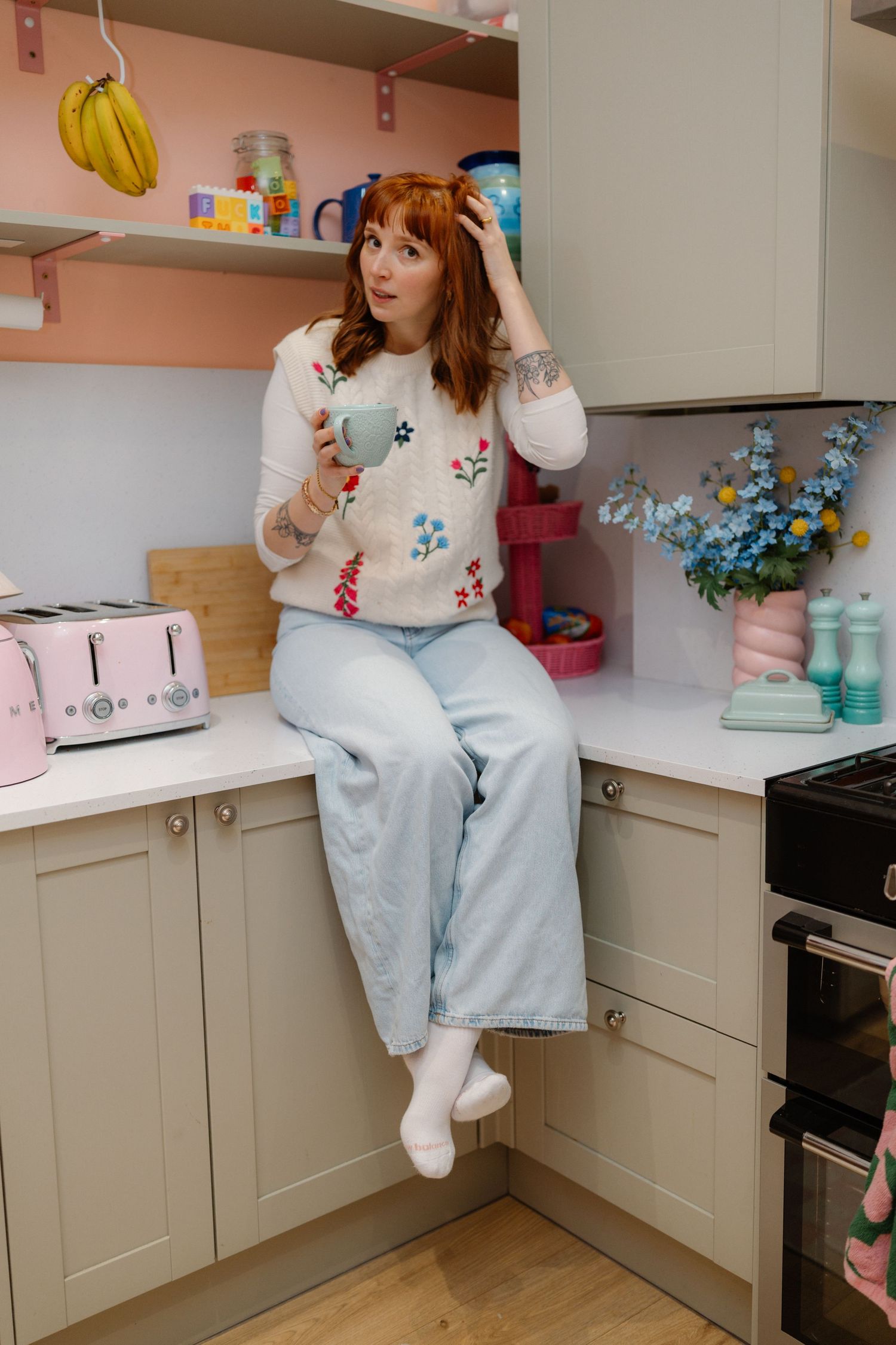 Candid kitchen scene with pastel decor and retro-style appliances.