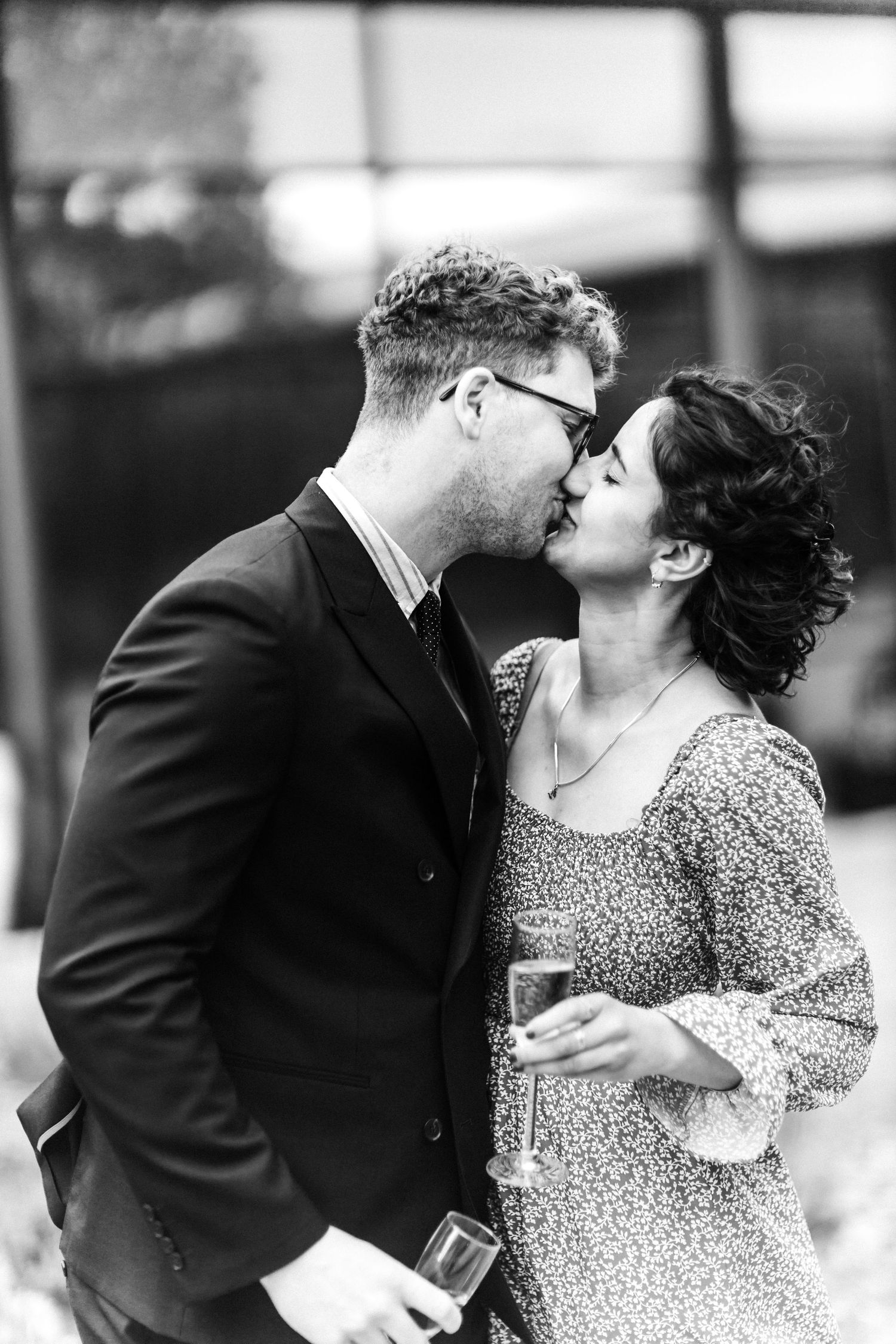 Kissing couple wedding outside of the Glass House, Edinburgh, Scotland.